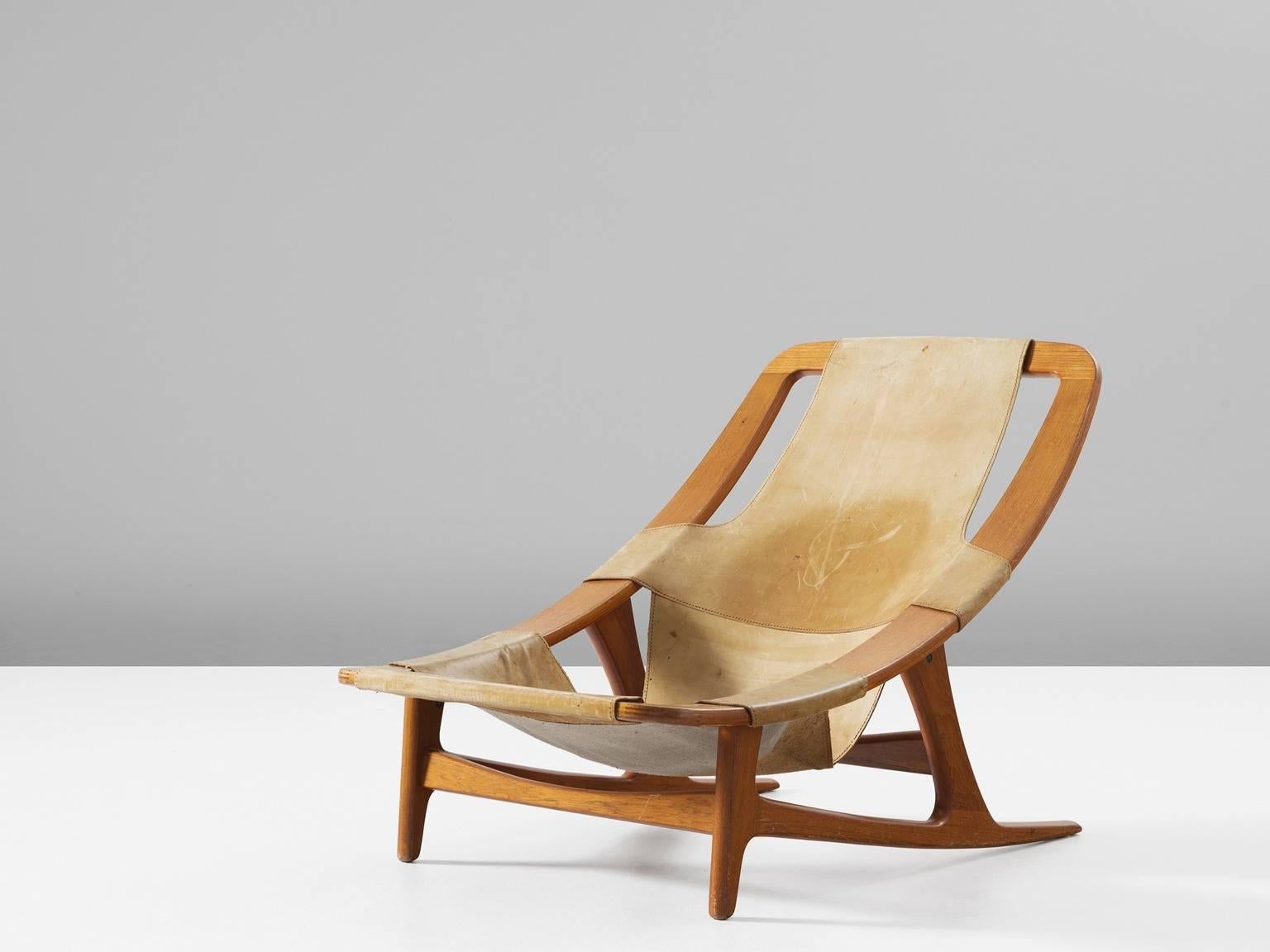 Lounge chair 'Holmenkollen', in teak and leather, by Arne F. Tidemand Ruud for Norcraft, Norway 1959. 

Fantastic lounge chair designed by Norwegian designer Arne F. Tidemand Ruud. This chair is very dynamic due it's design and shapes. The