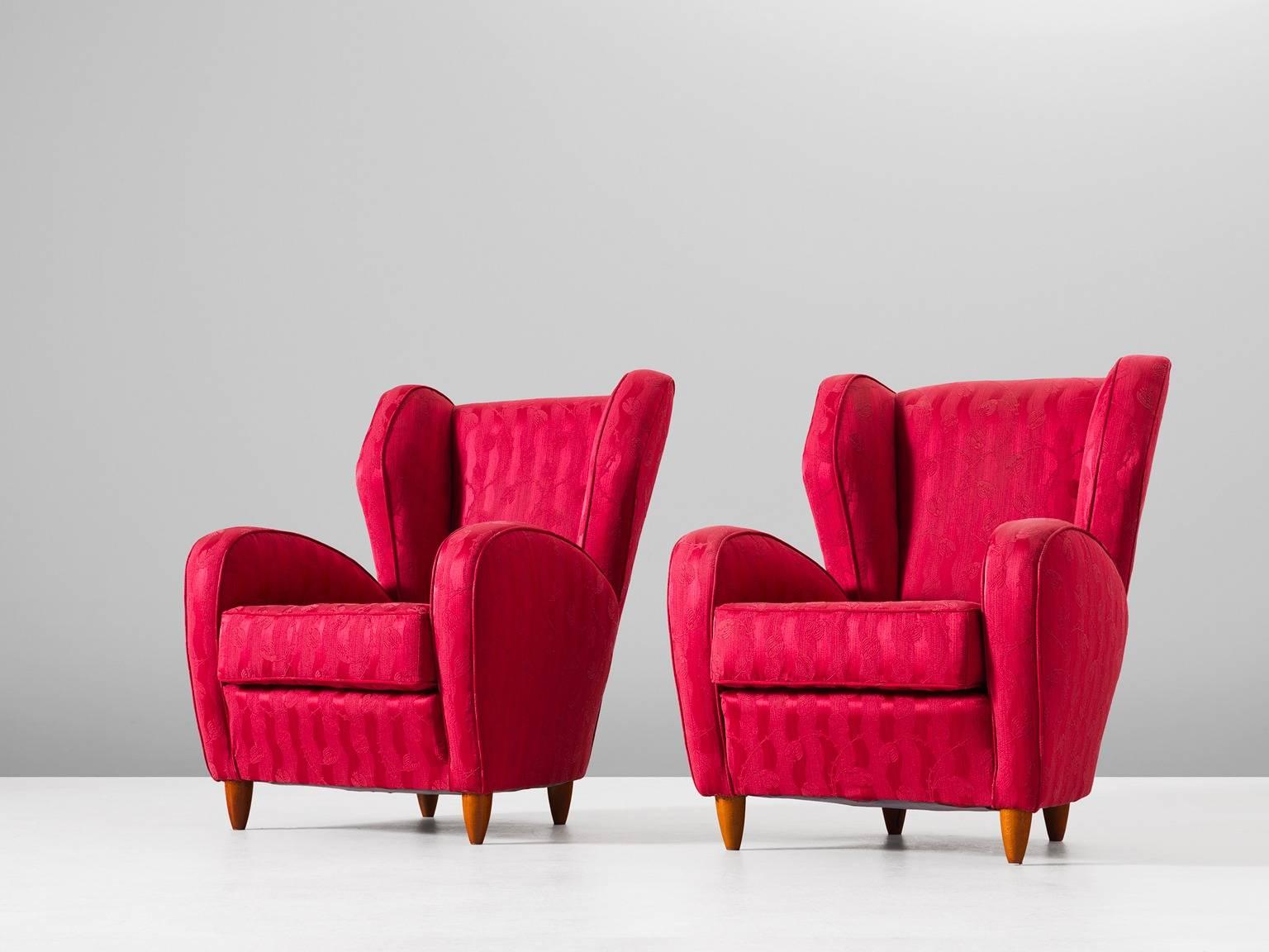 Set of two high back chairs, fabric and wood, Italy, 1950s. 

Pair of elegant Italian wingback chairs. The high armrests and back give this design a Classic and solid character. Beautifully curved with rounded edges. The back forms a beautiful