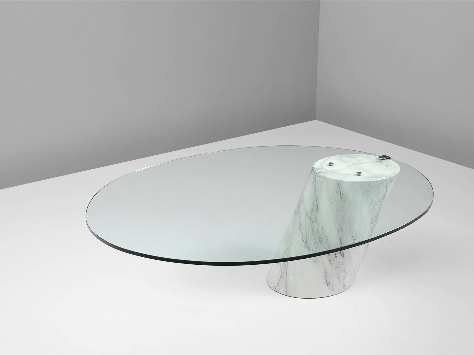 Cocktail table model K1000, in marble and glass, by Team Form AG for Ronald Schmitt, Switzerland circa 1974. 

This table is made of a solid Carrara marble base with a hardened clear glass top. The oval top is attached to the cylindrical base,