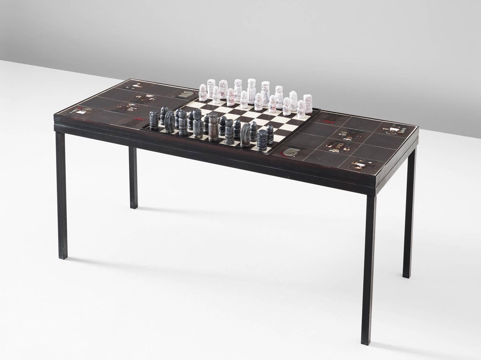 Table with ceramic chess pieces by Jan Ryheul for Perignem, Belgium, 1960s. 

Interesting table with chess-board and illustrations. The table consist of a metal base. On the top is the characteristic black-white chessboard and ceramic tiles with