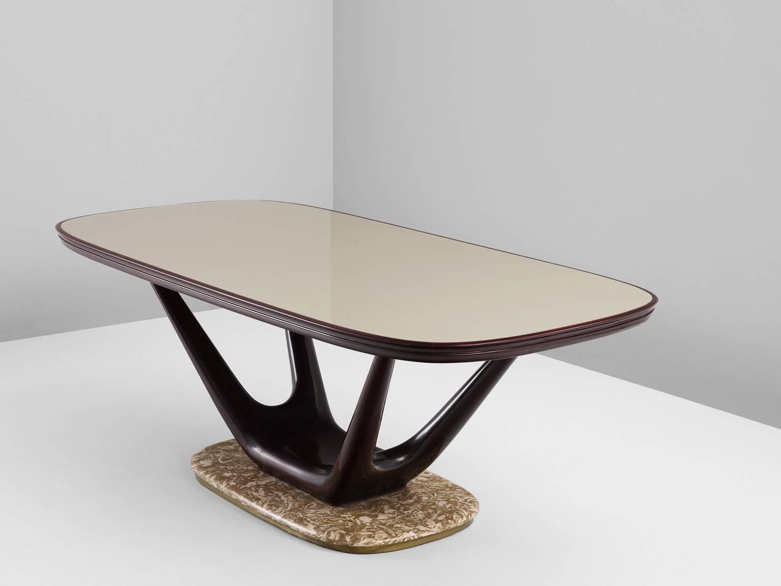 Table, in marble, glass and mahogany, Italy, 1950s.

Luxurious center table with marble base and glass top in the style of Italian designer Vittorio Dassi. A rectangular top with rounded edges. The top is made of glass with a beautiful champagne