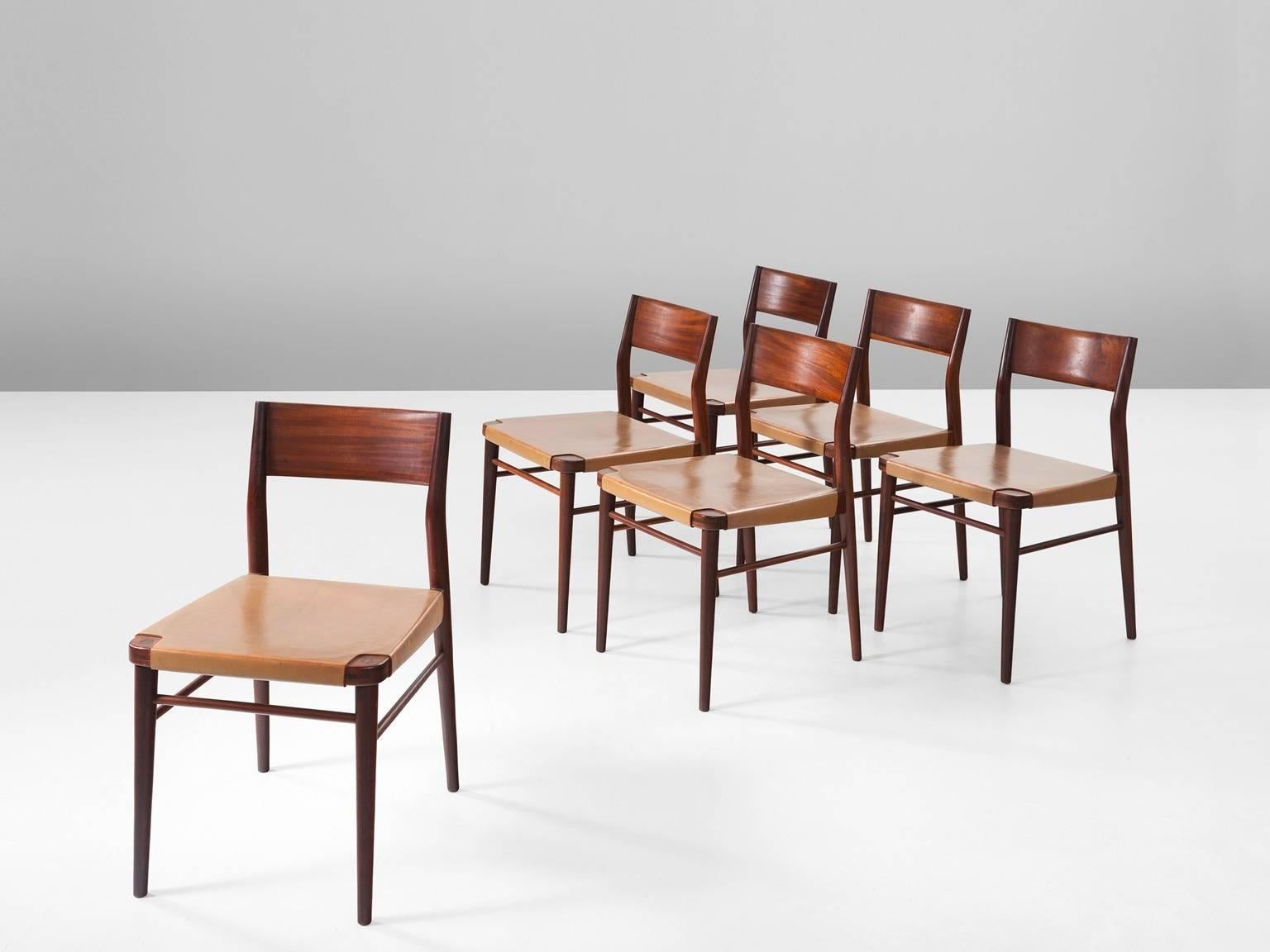 Set of six dining chairs, in leather and mahogany, Italy, 1950s.

Six dining room chairs with mahogany frame and cognac leather upholstery. These chairs are a great example of Italian Mid-Century design. They represent the open and fragile-looking
