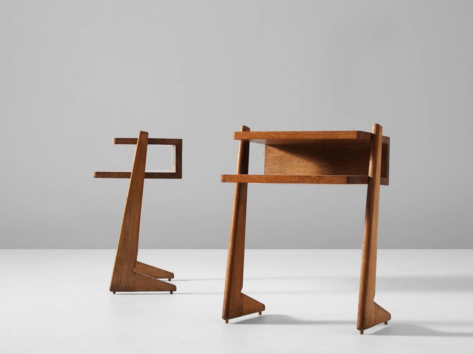 Pair of nightstands, in solid oak, by Guillerme et Chambron, France, 1960s.

Two nightstands in solid oak. Playful design with two levels. Rectangular Dual level top with two L-shaped legs. These stands provide an open and fresh look. The solid