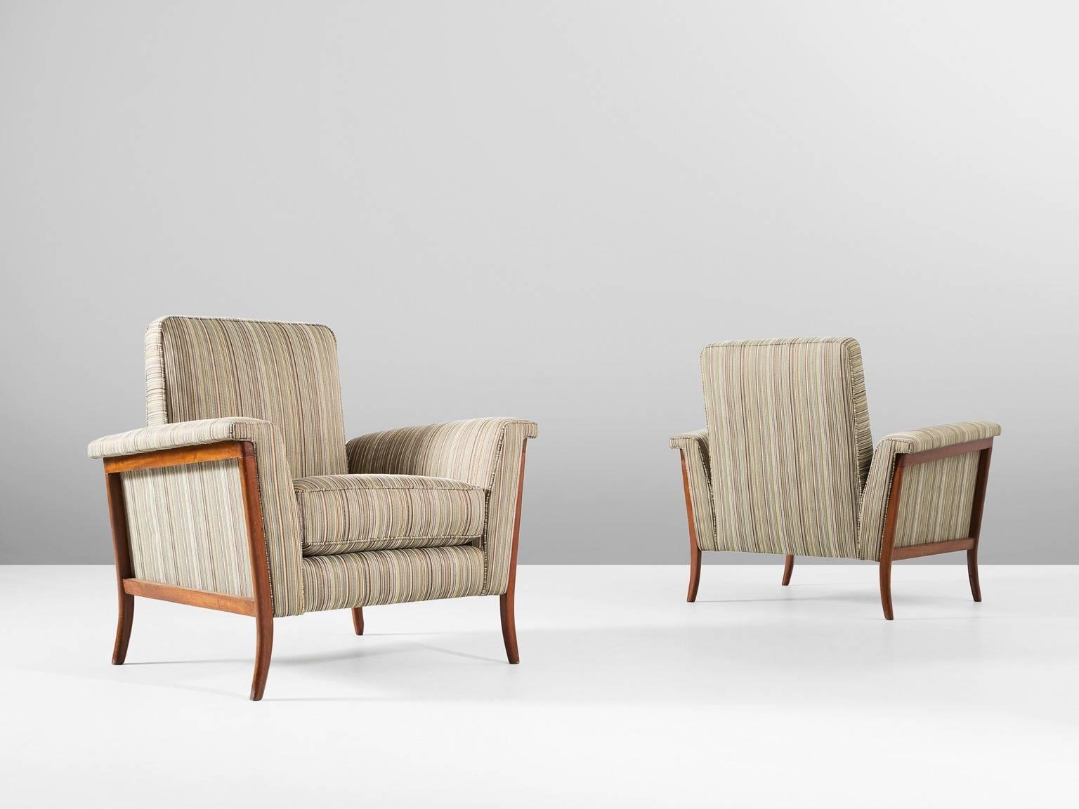 Pair of lounge chairs, in mahogany and fabric, Brazil, 1960s.

Elegant pair of Brazilian club chairs. The curved frame is made of mahogany and beautifully exposed on the outside of the shell. Due the lines the wide character of this chair is