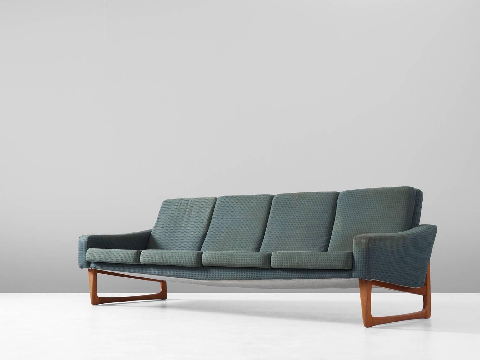 Four-seat sofa, in teak and fabric, Scandinavia, 1960s.

Large four-seat sofa with beautiful detailed teak frame. The frame has characteristic sled legs with rounded edges and diagonal cross connections. By their high and open legs, the large sofa