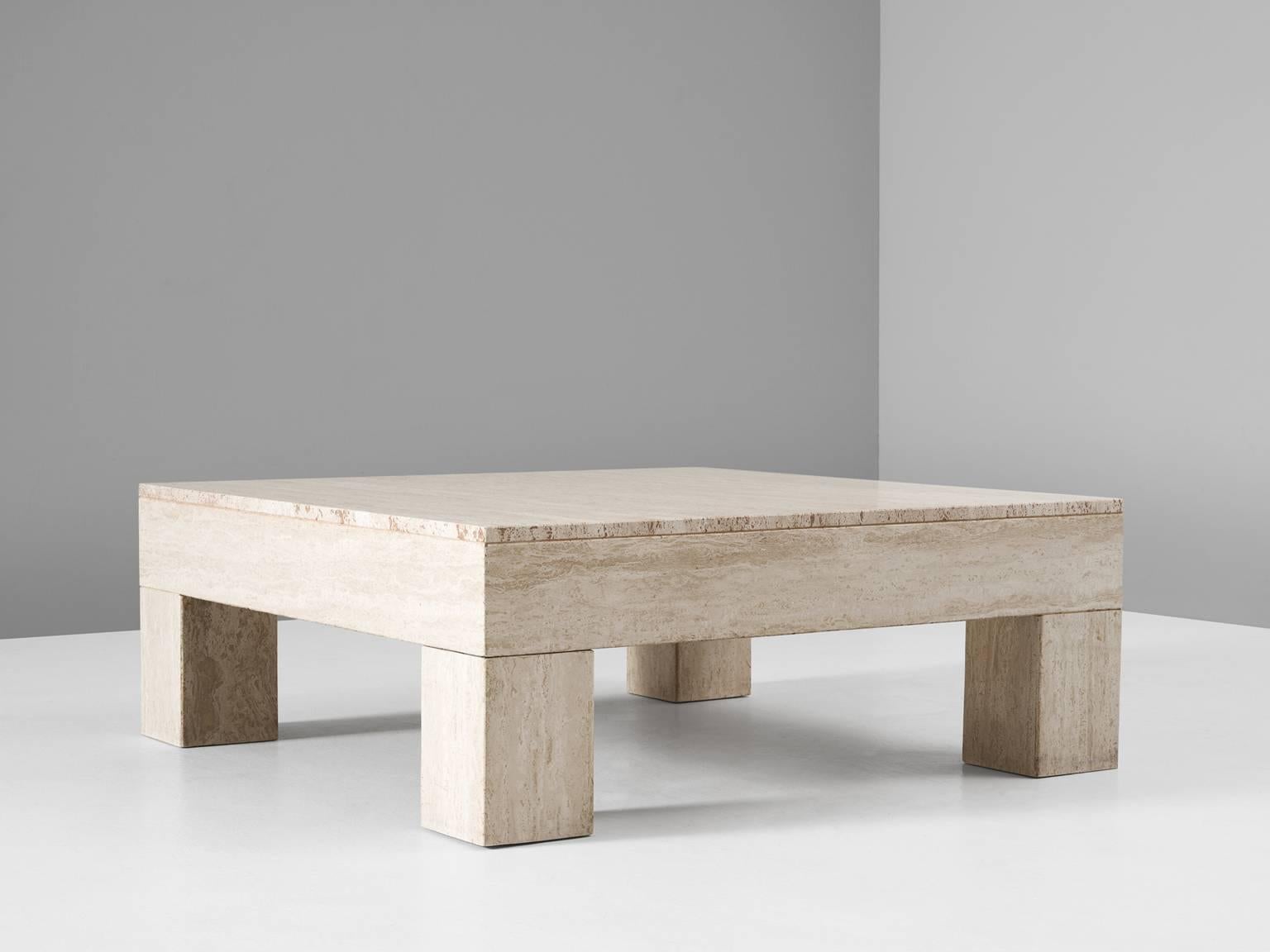 Square coffee table in travertine, Europe, 1970s. 

The basic design of this coffee table shows nice proportions. The thickness of the top part and the legs is equal, which emphasizes the clearness of the design.

The sturdy square legs are
