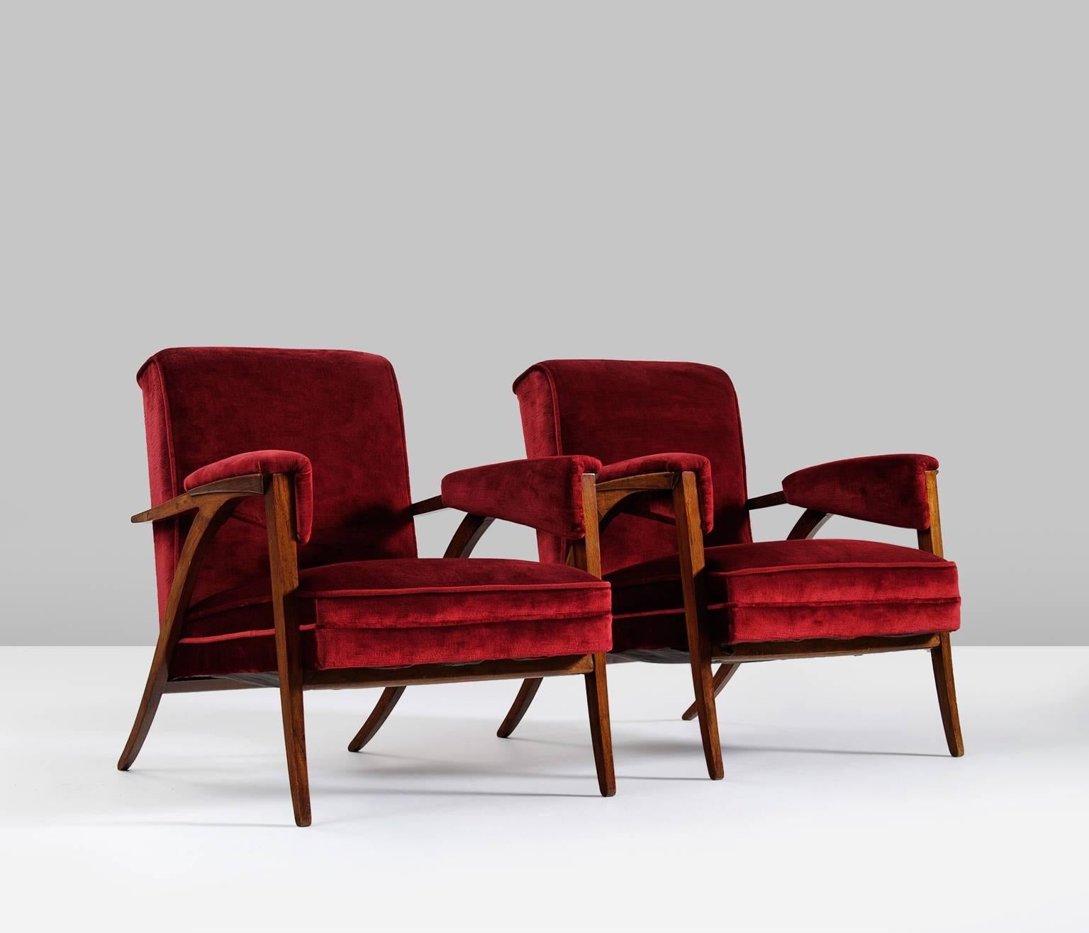 Wonderful pair of armchairs in red velvet, Italy, 1950s.

This extraordinary piece was made in mahogany and shows a very well-crafted frame. The original red velvet upholstery is in a beautiful condition and shows minor signs of age.

The