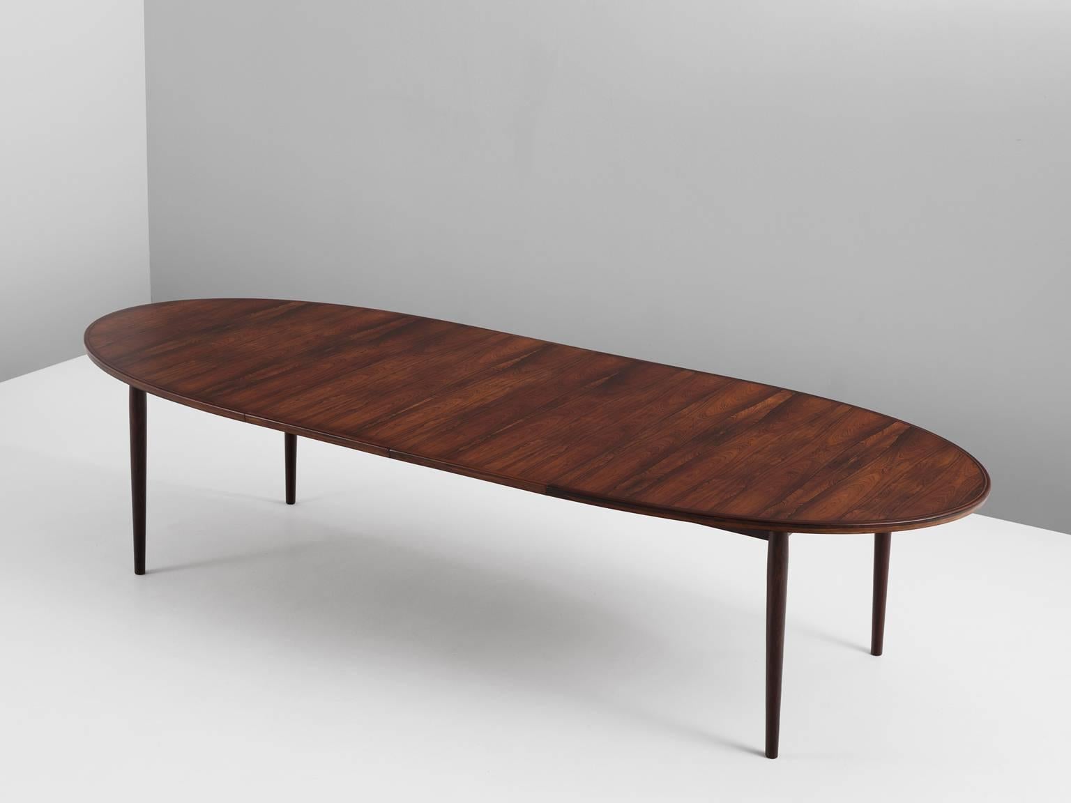 Dining table in rosewood by Arne Vodder for Sibast, Denmark, 1950s.

Large oval table in rosewood. This extendable table comes with two leaves, which gives it an extra length of one meter. The design is basic and modest. Four cylindrical tapered