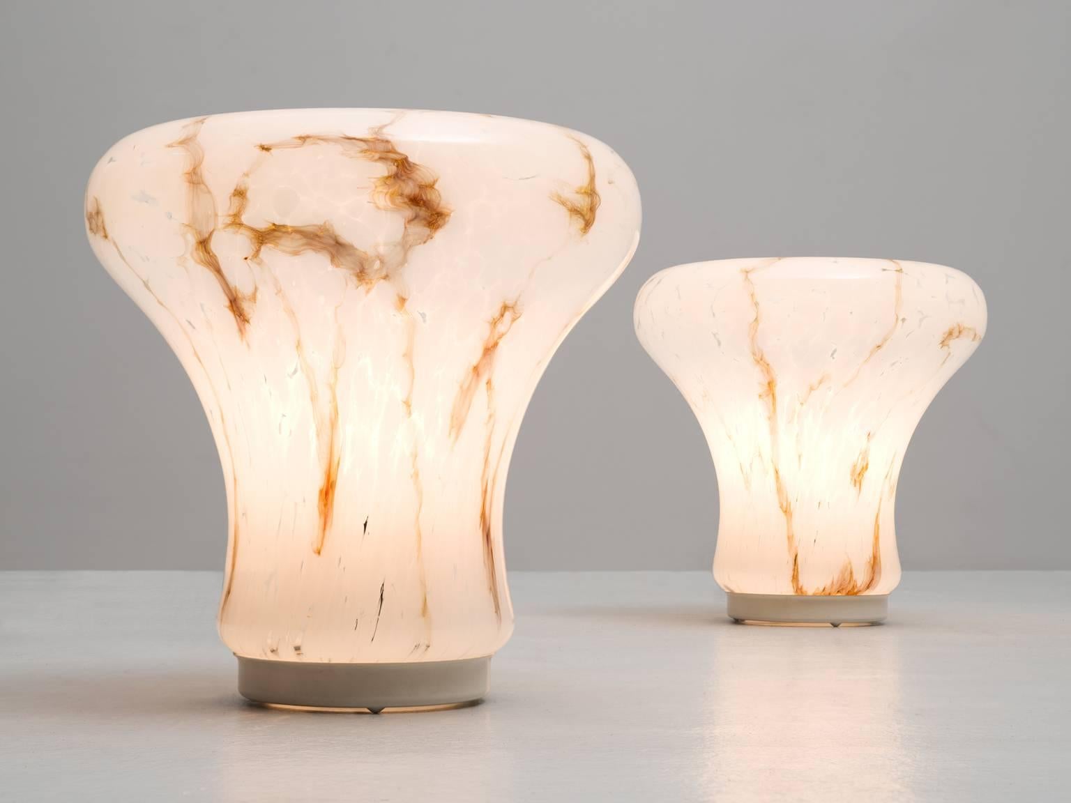 Pair of table lights, in glass, Europe, 1970s.

Interesting pair of two table lamps in glass. These lights have a beautiful shape which reminds of a mushroom. The art-glass shows a white surface with brown stripes and sweeps. Due form and material