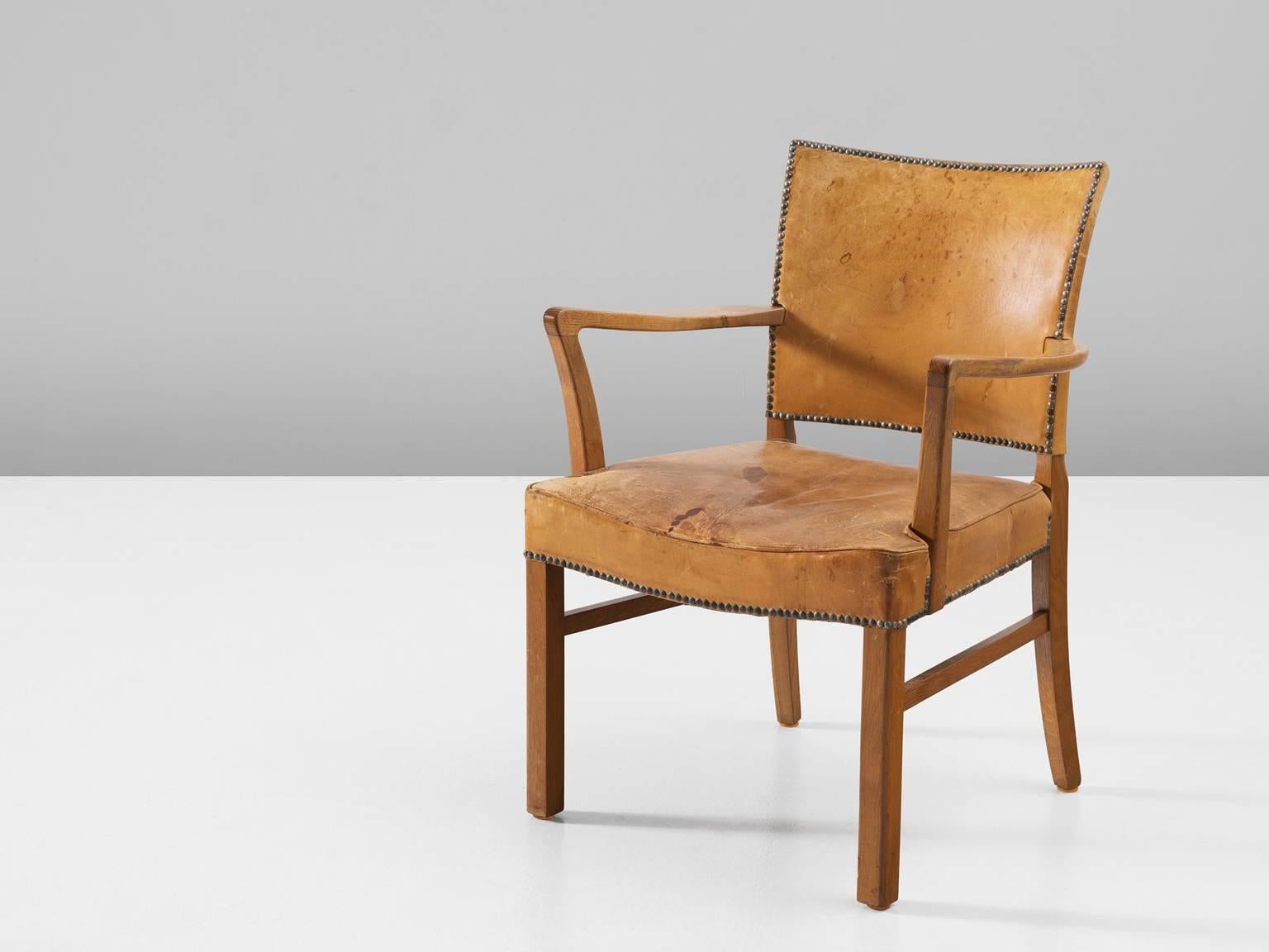 Armchair, in leather and oak, Denmark, 1950s. 

Refined and elegant armchair. This piece echoes the classical style of the 18th century in combination with Scandinavian Modernism. This side chair consist of a solid oak frame. The back legs are