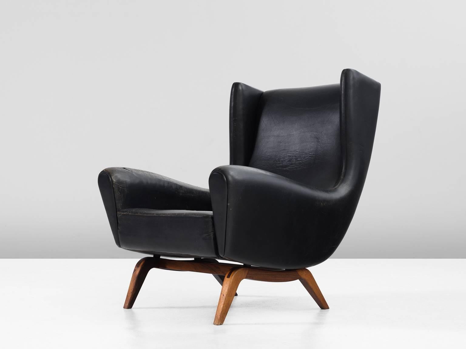 Lounge chair model 110 in leather and rosewood by Illum Wikkelsø for Søren Willadsen, Denmark, 1950s. 

This well-designed armchair shows an unusual elegance and great eye for detail, combined with outstanding craftsmanship, which is