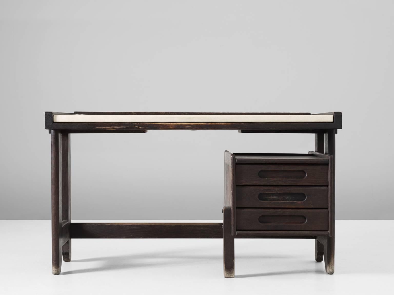 Desk, in oak and faux-leather, by Guillerme et Chambron, France, 1960s.

Beautiful shaped desk in dark stained oak by French designer duo Jacques Chambron and Robert Guillerme. This executive desk shows some nice contrasts. Like the off-white