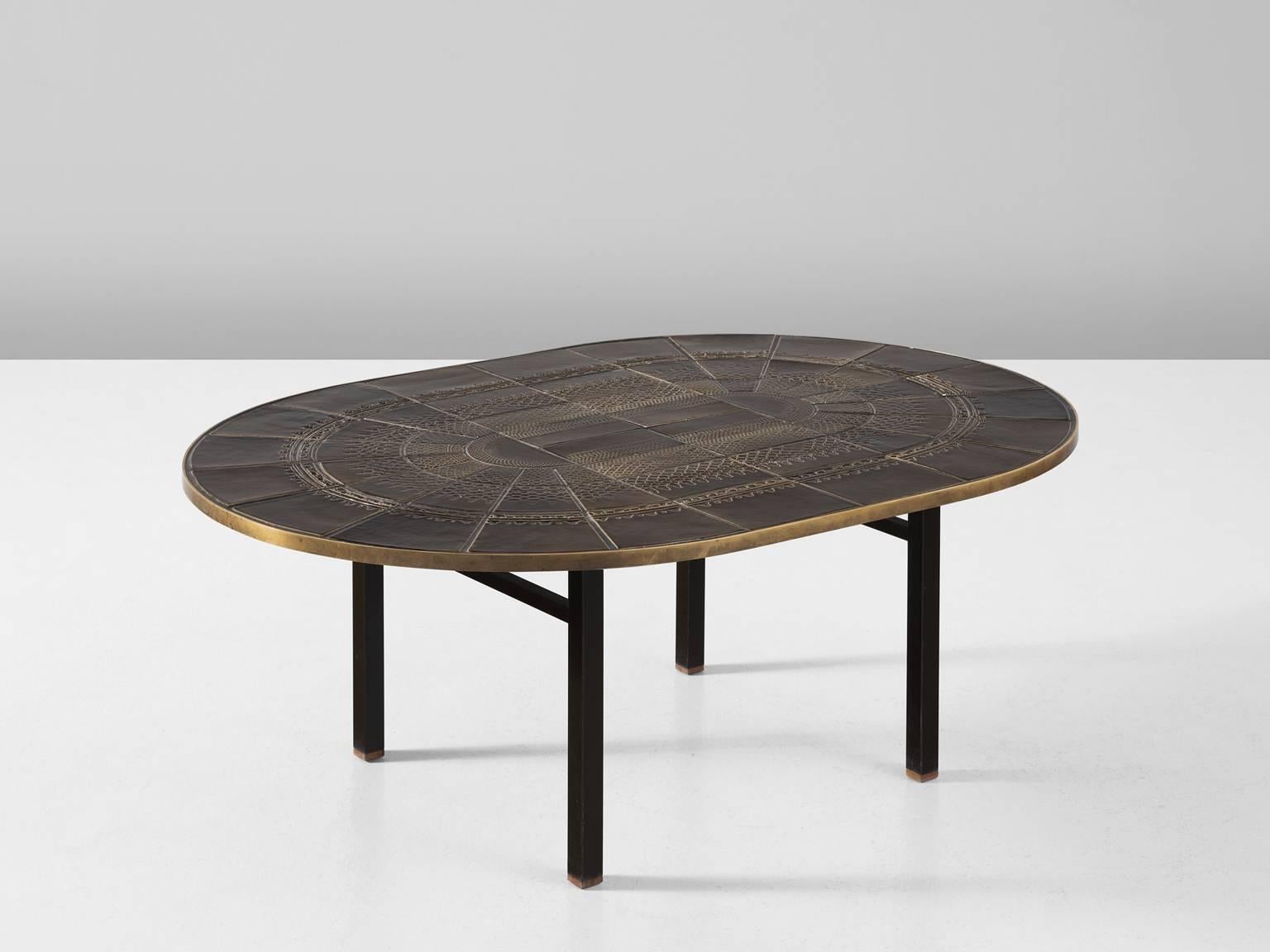 Coffee table in ceramic, metal and brass, Scandinavia, 1950s.

Beautifully detailed oval coffee table with ceramic tiles top. The frame is made of black coated metal to carry the heavy top. This oval shaped top is made of brown glazed ceramic