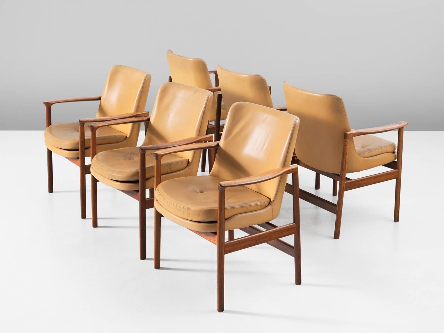Set of six armchairs, in rosewood and leather by Ib Kofod-Larsen, Denmark, 1950s. 

Set of six elegant conference chairs by Danish designer Ib Kofod-Larsen. These dining chairs have the characteristics of the iconic Elizabeth chair of