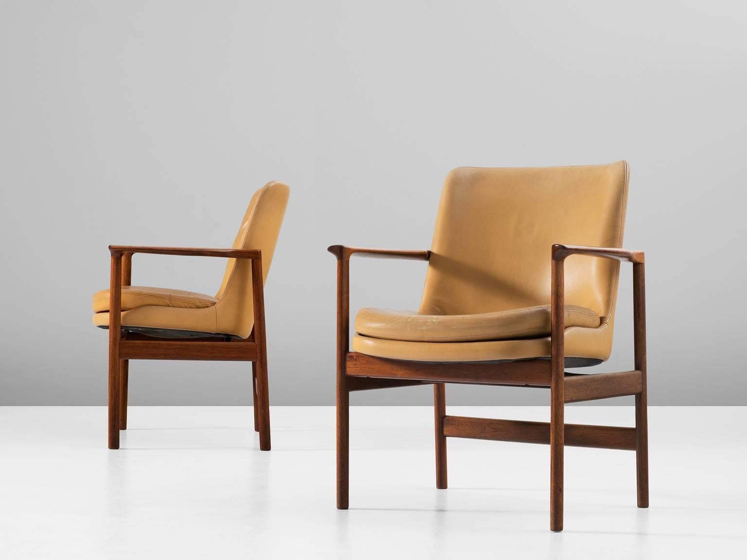 Set of two armchairs, in rosewood and leather by Ib Kofod-Larsen, Denmark, 1950s. 

Set of two elegant easy chairs by Danish designer Ib Kofod-Larsen. These dining chairs have the characteristics of the iconic Elizabeth chair of Kofod-Larsen. The
