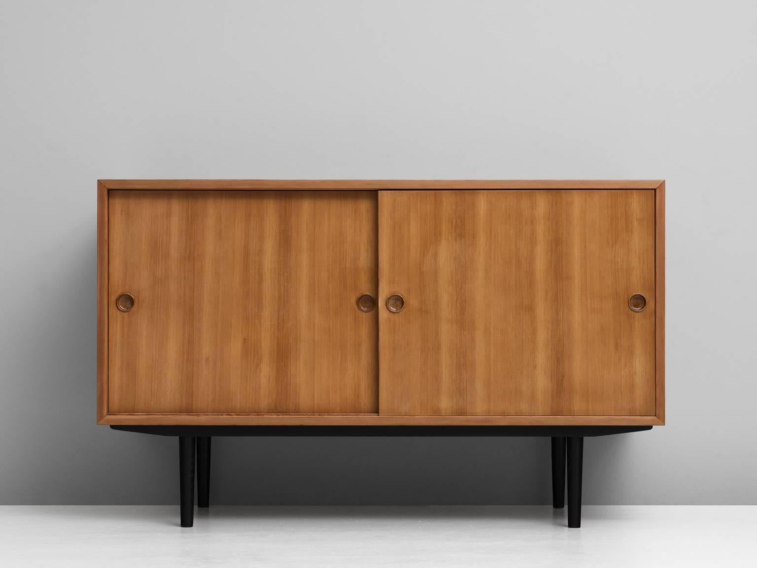 Two cabinets, in Oregon pine, by Børge Mogensen for Ab Karl Andersson & Söner, Denmark, 1950s. 

A rare and small sideboards with two sliding doors. The blond colored wood beautifully contrast tot the black lacquered base. Nicely detailed base with