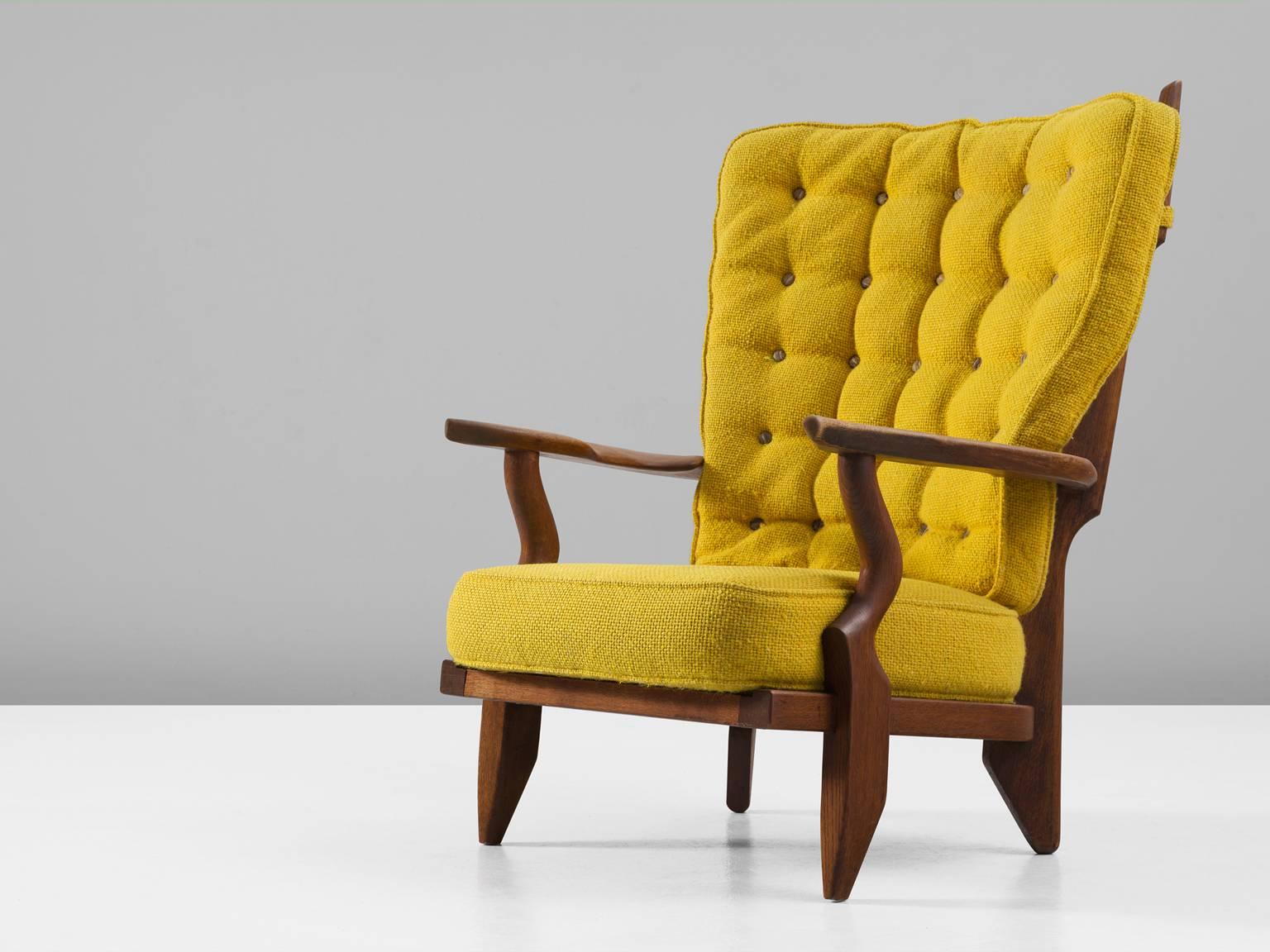 'Grand Repos' lounge chair in oak and fabric, by Guillerme et Chambron, France, 1960. 

High back lounge chair in solid oak with the typical characteristic decorative details at the back and capricious forms of the legs. Very comfortable, great