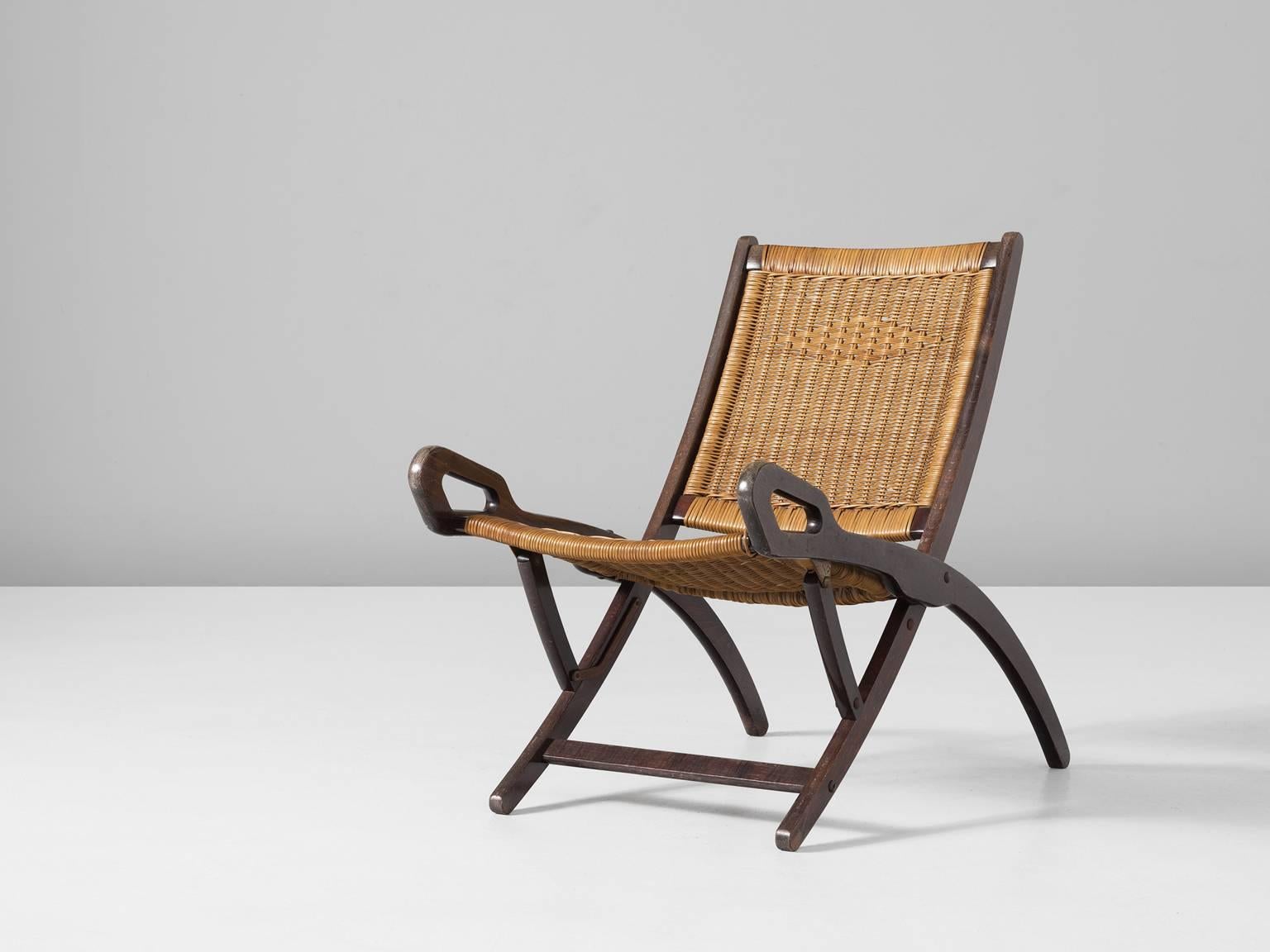 'Nifea' folding chair, in beech and cane, by Gio Ponti for Brevetti Reguitti, Italy, 1958.

Exclusive easy chair by Gio Ponti. This chair is upholstered with a woven rattan seating and back. This is what makes this chair unique, not many of these