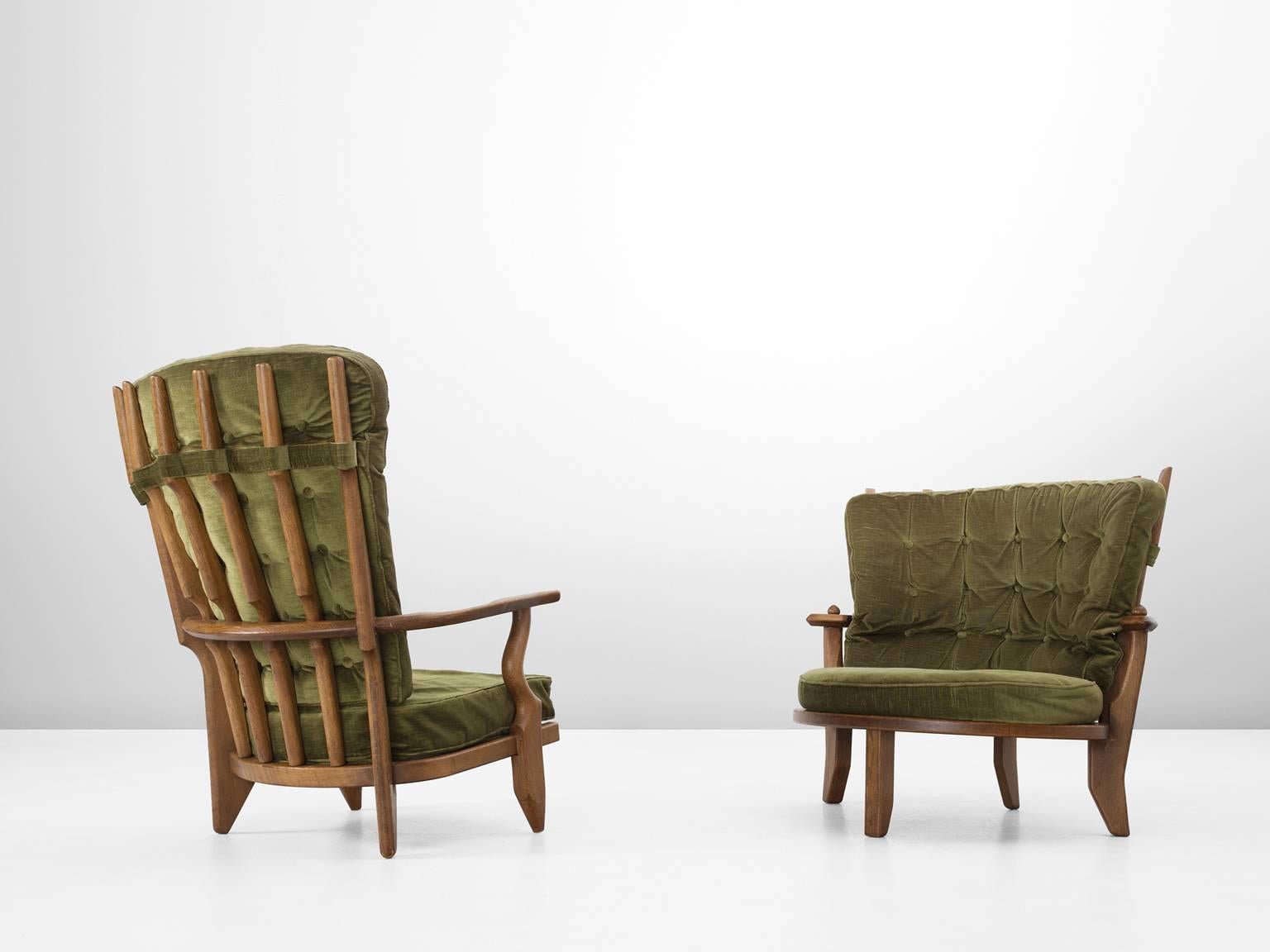 Set of two armchairs, in oak and fabric by Guillerme et Chambron, France, 1960.

High back 'Adam' lounge chair and 'Eve' easy chair in solid oak with the typical characteristic decorative details at the back and capricious forms of the legs. Very