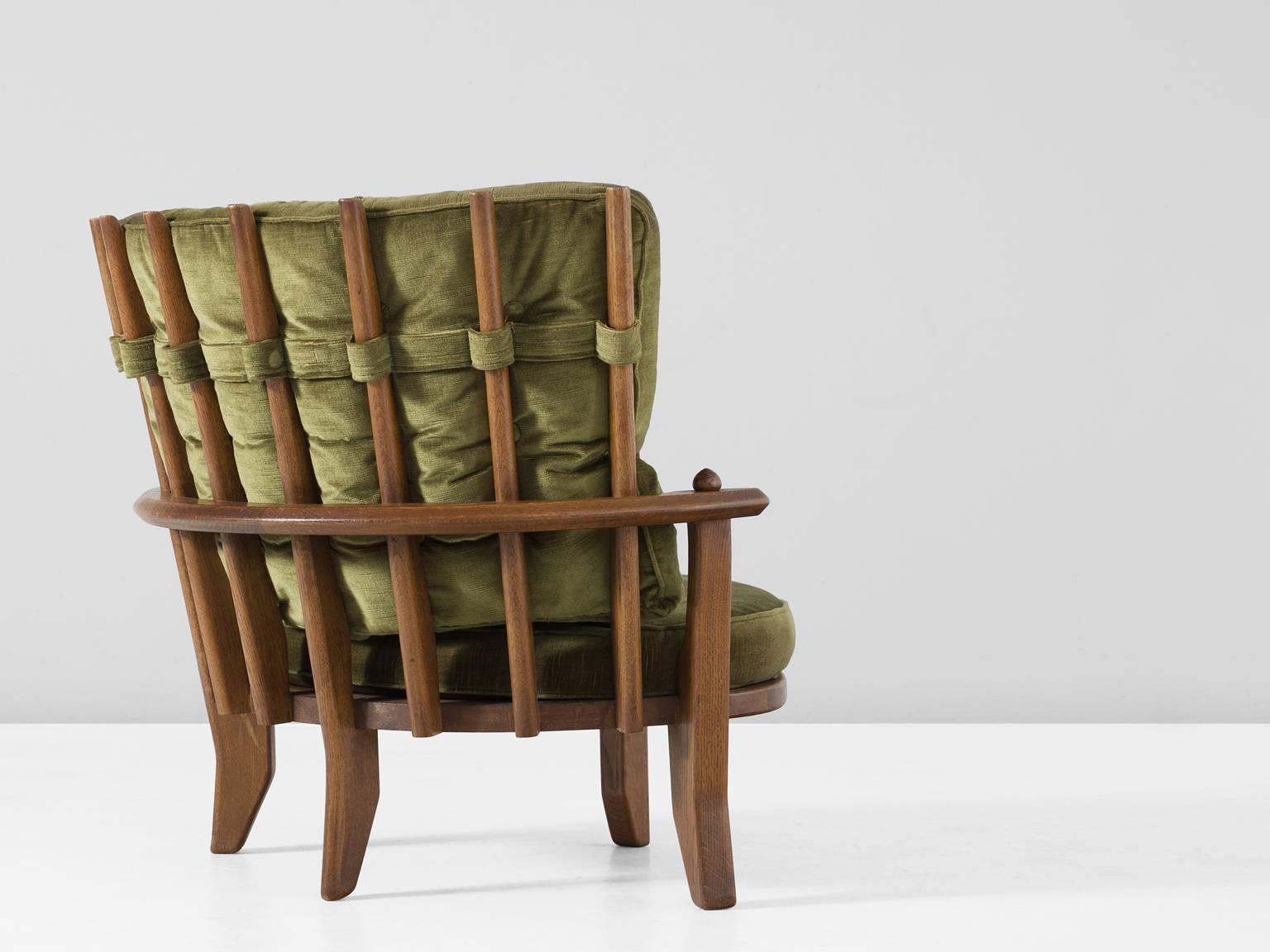 Lounge chair, in fabric and oak, by Guillerme & Chambron, France, 1960s. 

'Eve' armchair in solid oak with the typical characteristic decorative details at the back and capricious forms of the legs. Very comfortable, great statement piece in