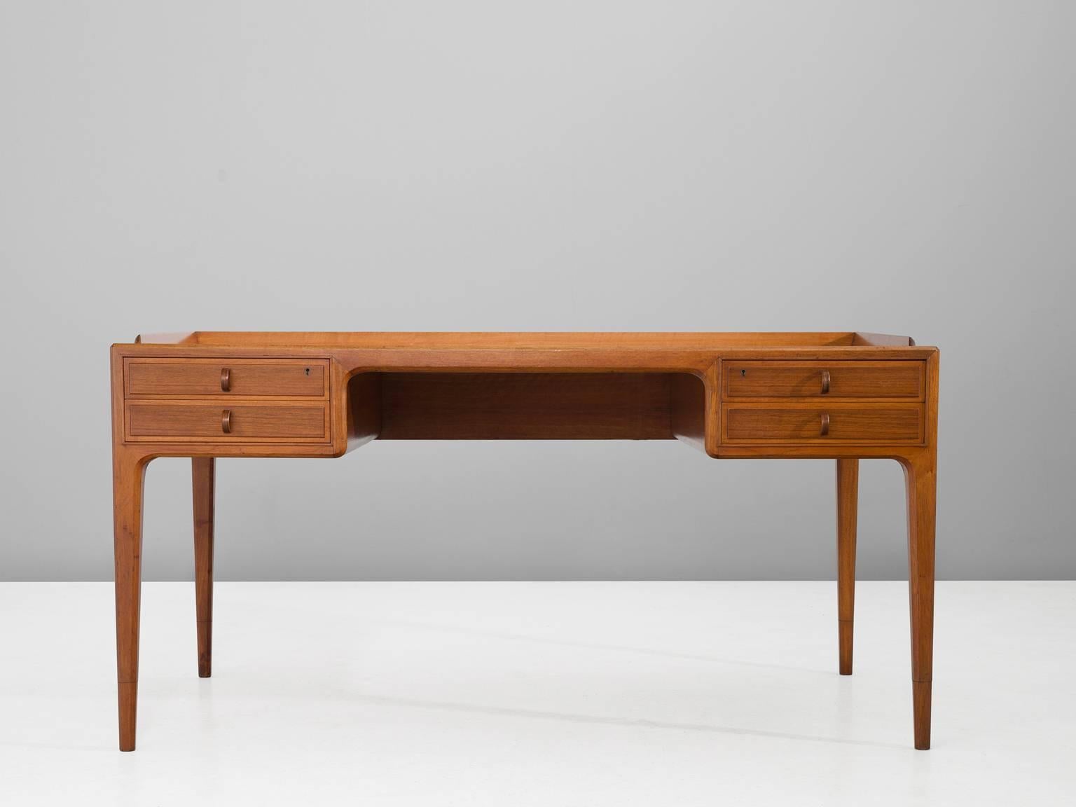 Desk in teak by Bernt Fridhagen for Bodafors, Sweden, 1961.

Elegant desk in teak. The back is also executed in teak, which makes it a highly versatile item which could be placed freely in the room. Nice open character due the high legs. Al