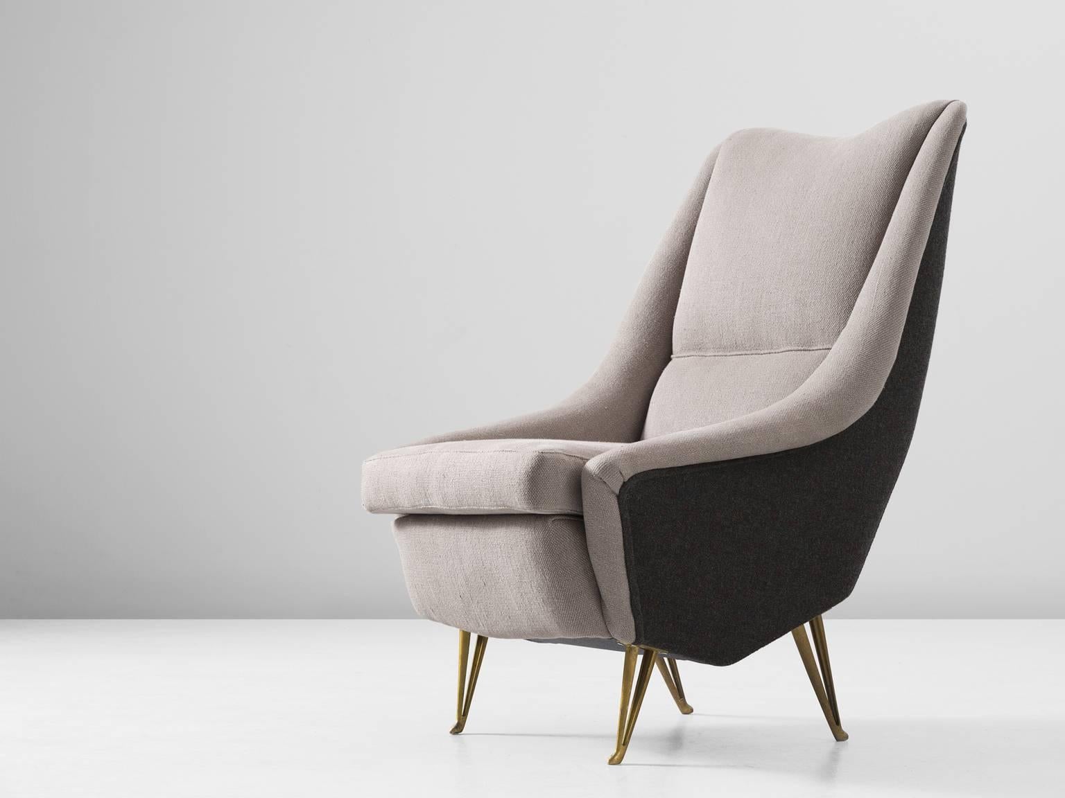 Lounge chair, in fabric and metal, for ISA, Italy, 1950s.

Elegantly shaped Italian lounge chair in two-tone grey upholstery. Beautiful tapered legs in brass colored metal, with a nice v-shaped opening. The dark grey upholstered outside emphasize