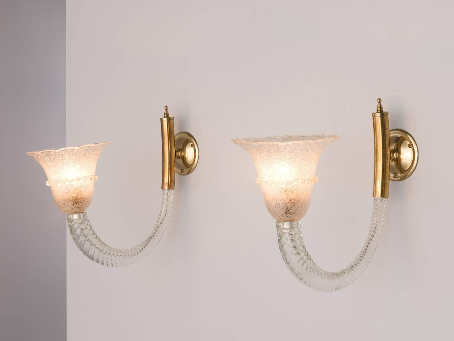 Pair of wall lights, in Murano glass and brass, for Barovier & Toso, Italy, 1940s.

Highly elegant pair of sconces by Ercole Barovier. These horn shaped wall lights have a royal and luxurious appearance. The horn of spiral clear glass is mounted
