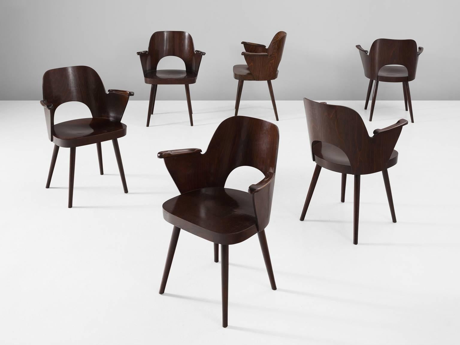 Set of six armchairs, in beech, by Oswald Haerdtl for Thonet, Czech Republic, 1955.

Set of six bended plywood armchairs in beech. These chairs were designed by Oswald Haerdtl for the famous bentwood manufacturer Thonet. These chairs show nice