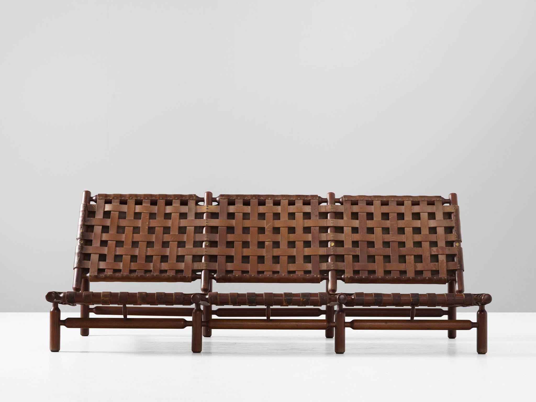 Sofa in teak and leather by Ilmari Tapiovaara for Esposizione La Permanente Mobili, Italy, 1957.

Rare three seat sofa by Finnish designer Ilmari Tapiovaara. This organic design features beautiful leather support strapping, which are an artwork in