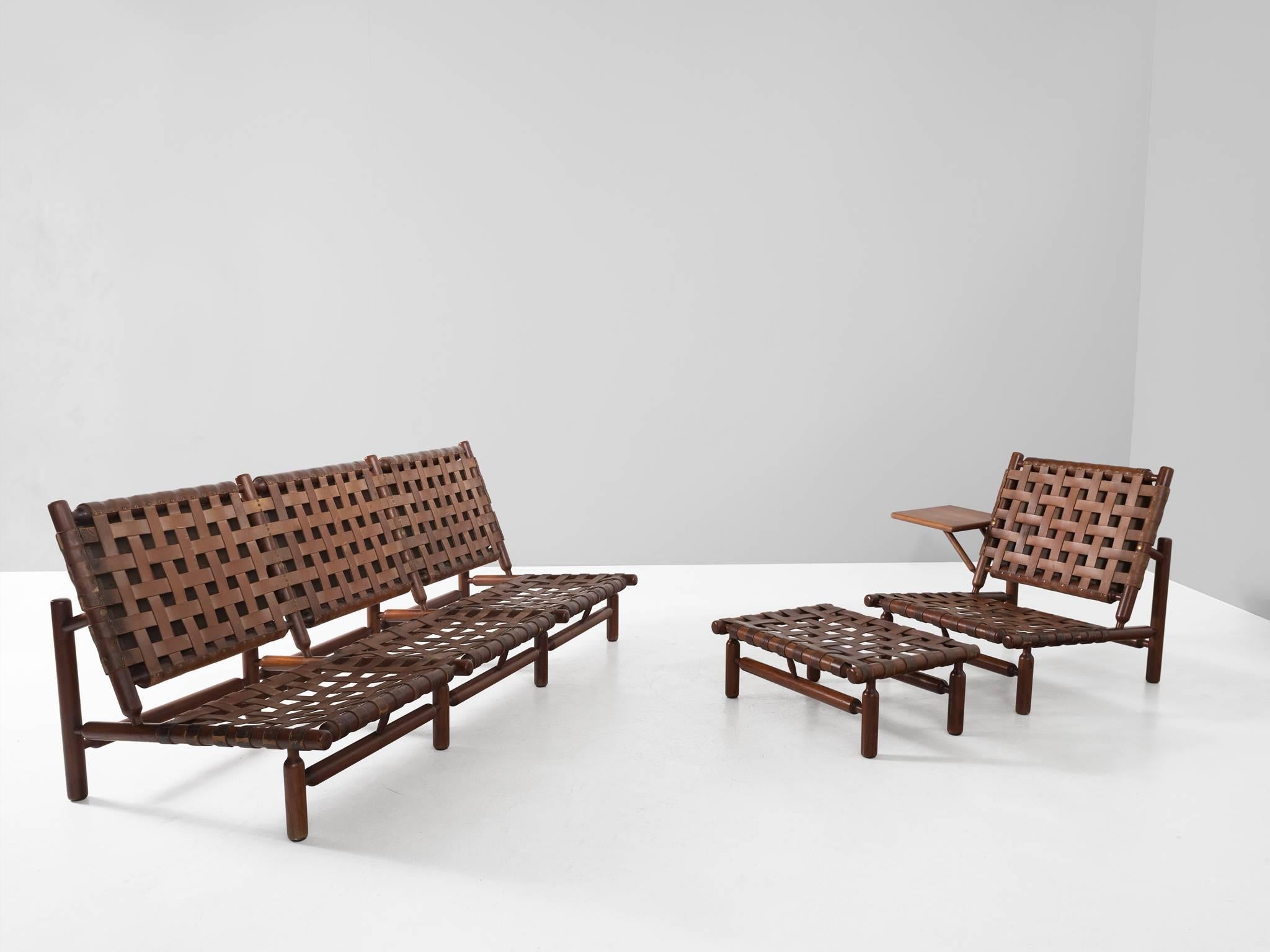 Sofa and lounge chair, in teak and leather, by Ilmari Tapiovaara for Esposizione La Permanente Mobili, Italy, 1957. 

Rare three-seat sofa and lounge chair by Finnish designer Ilmari Tapiovaara. This organic design features beautiful leather support