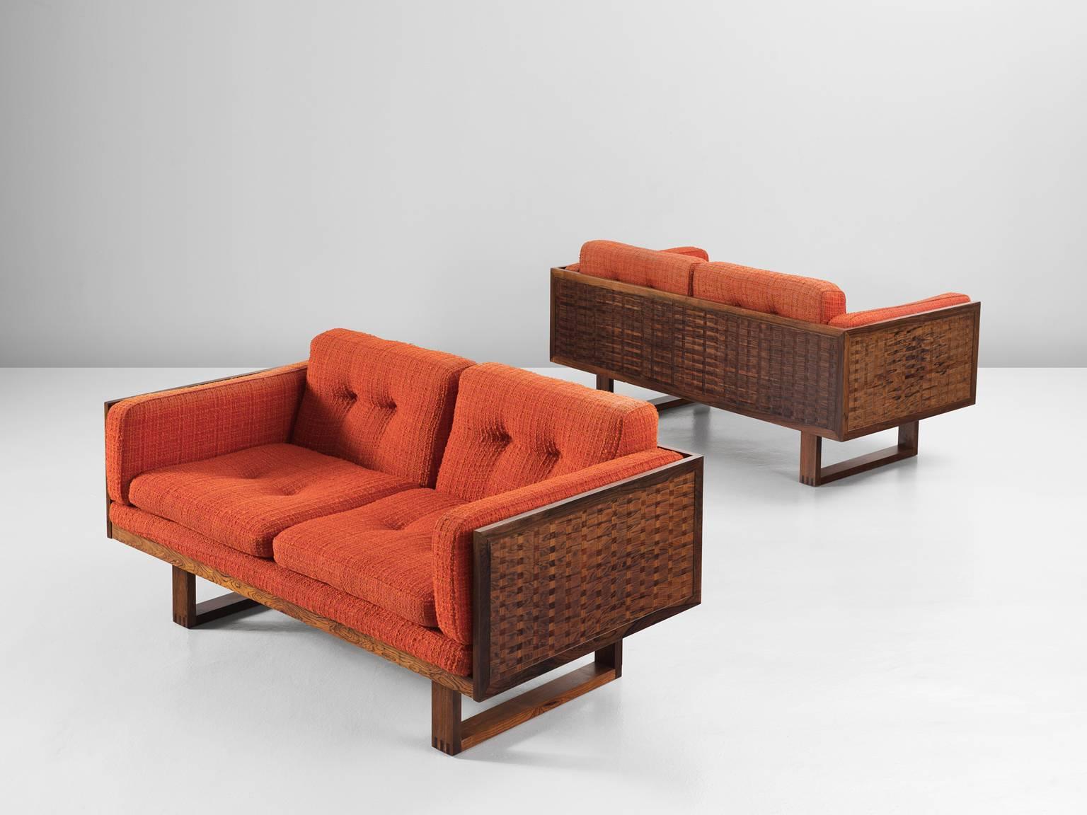 A pair of sofas, in rosewood and fabric, by Poul Cadovius for France & Søn, Denmark, 1960s. 

Set of two settees by Danish designer Poul Cadovious. The frames consist of rosewood. Two sled-legs provide an open look to the more closed sofa. All