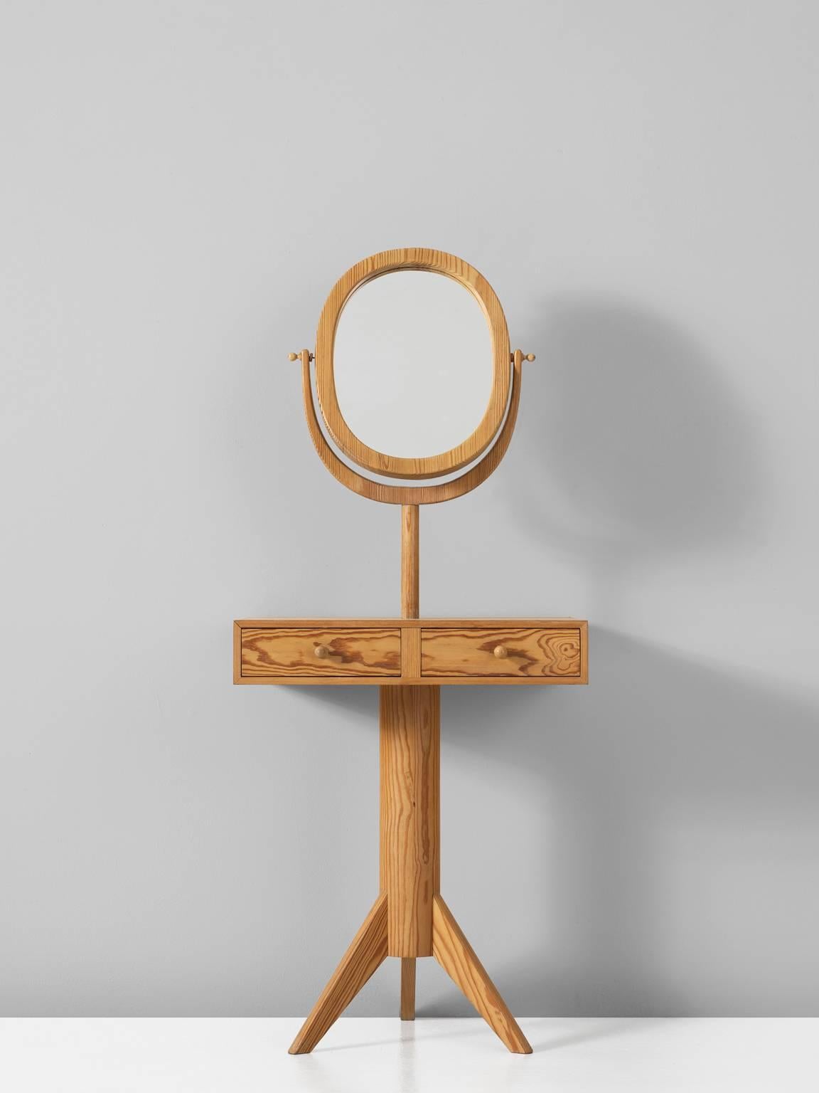 Dressing table, in pine and glass, by Illums Bolighus, Sweden, 1950s.

Interesting vanity in solid pine attributed to Carl Malmsten. This side table shows an interesting composition. A tripod base holds the cylindrical legs. The storage