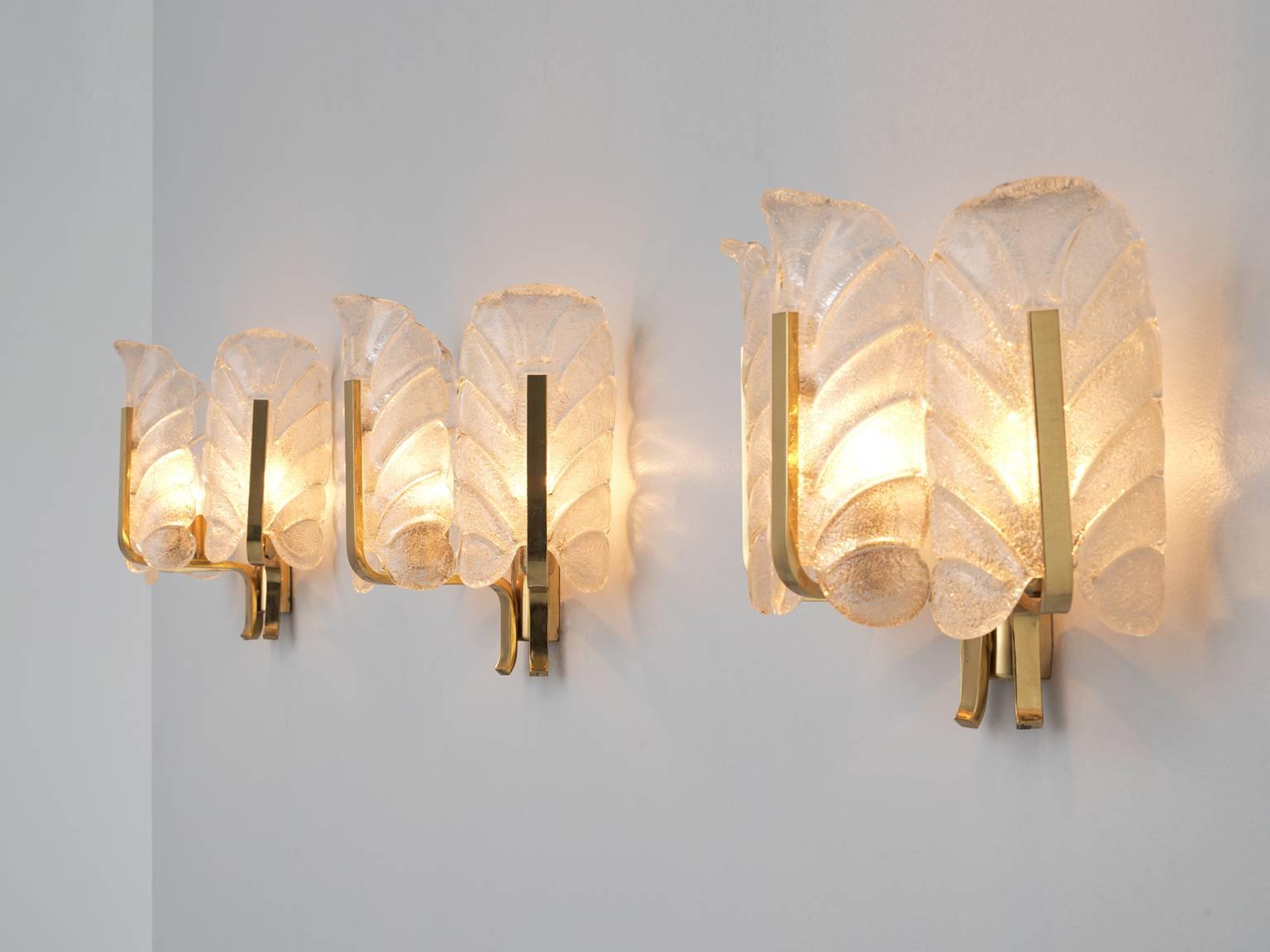 Set of 12 wall lights, in brass and glass, Europe 1970s. 

Large set of twelve elegant wall lights in brass and structured Murano glass. They are made in the style of Carl Fagerlund. Each light consists of three glass shades, all shaped as a nice