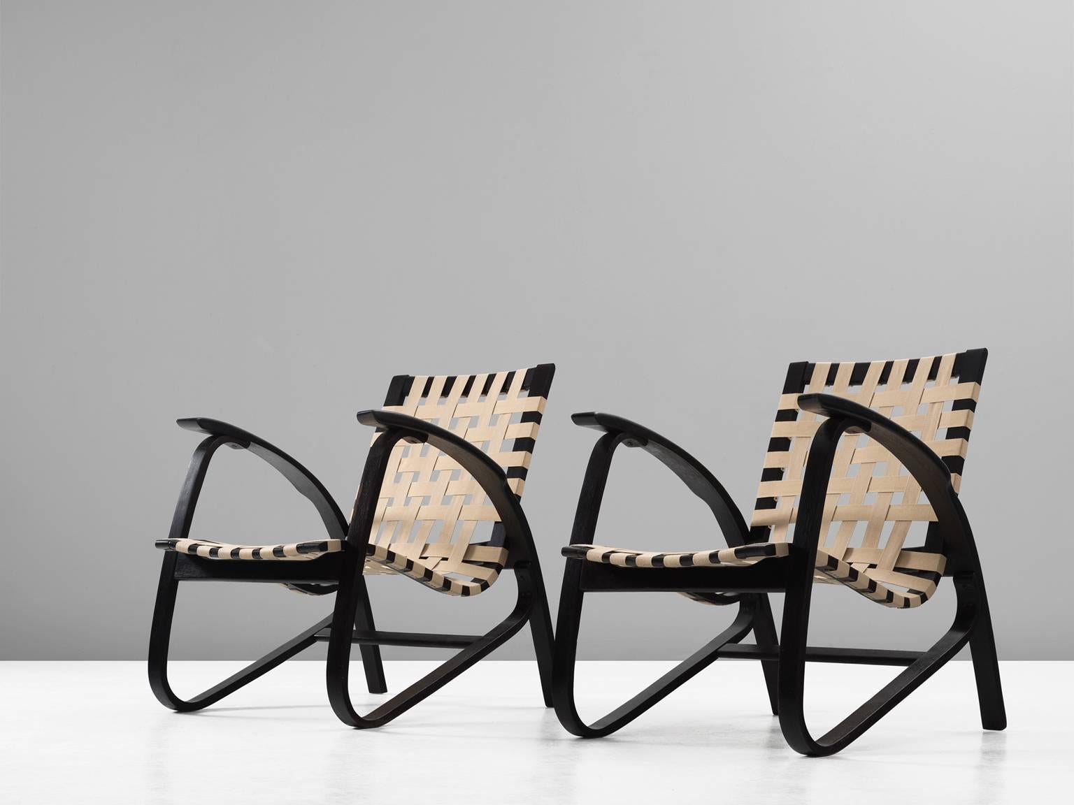 Pair of lounge chairs, in wood and canvas, by Jan Vanek for UP Zavodny, Czech Republic 1930s. 

Stunning pair of dynamic armchairs designed by Czech architect Jan Vanek, who was a contemporary of Jindrich Halabala. These chairs are upholstered