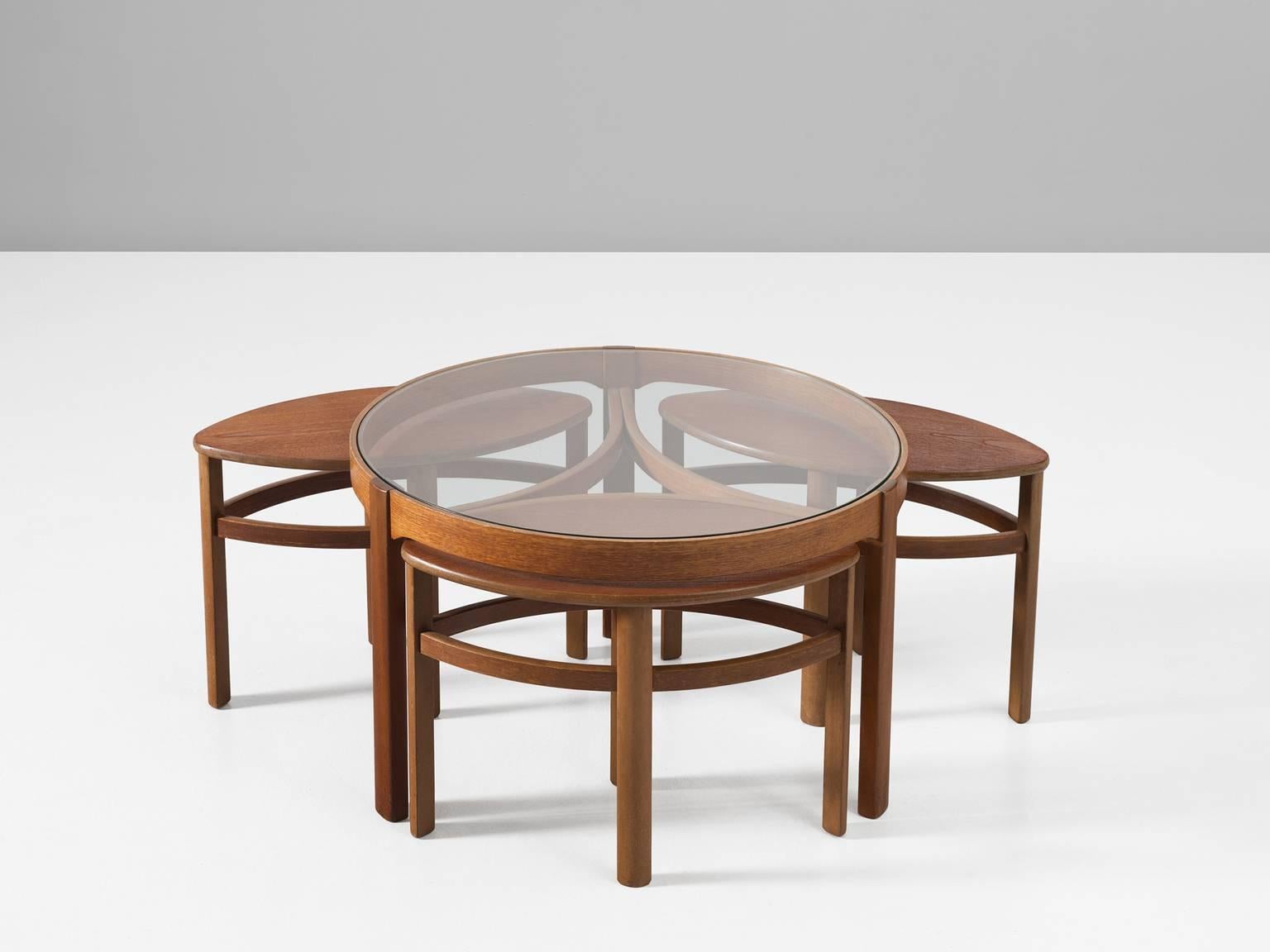 Nesting tables, in teak and glass, Scandinavia 1950s.

Beautiful set of a round coffee table and three side tables in teak. The design is simplistic, yet combined they form a beautiful set of leaves. The large table is round with a clear glass