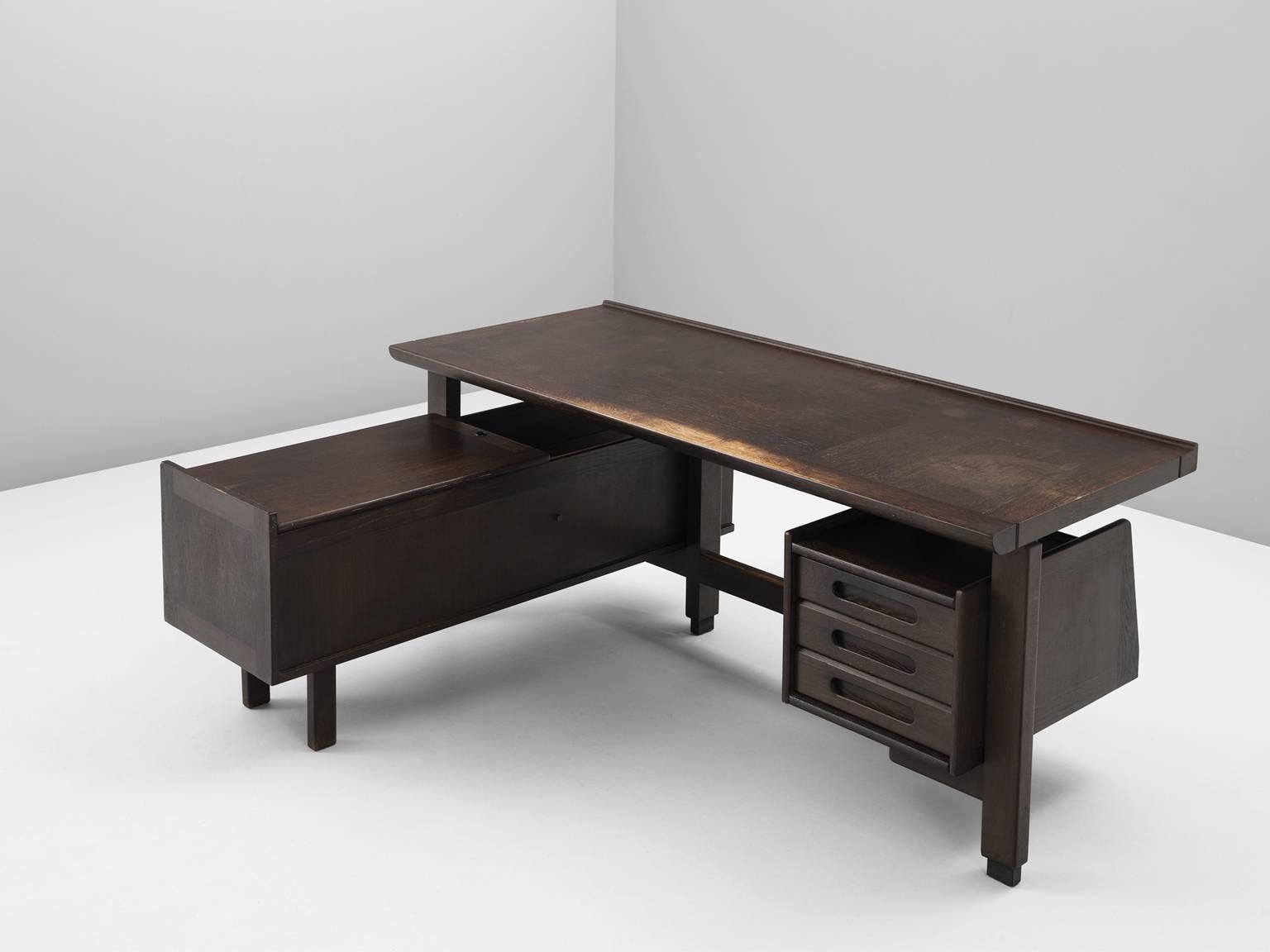 Corner desk in stained oak, by Guillerme et Chambron, France, 1960s. 

Corner desk by French designer duo Guillerme and Chambron. This executive desk shows the fine craftsmanship and line work that characterizes the work of this designer duo. The
