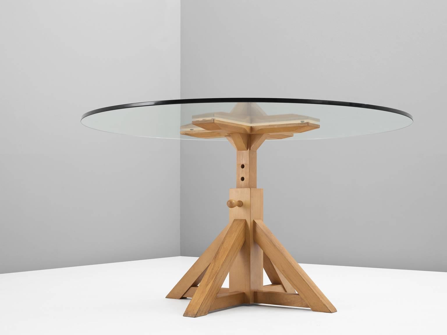 Table, in beech and glass, Europe, 1970s. 

Height adjustable dining room table with a round glass top, designed after the works by Enzo Mari. The beech frame has several positions on which the height can be determined for the ideal height for the