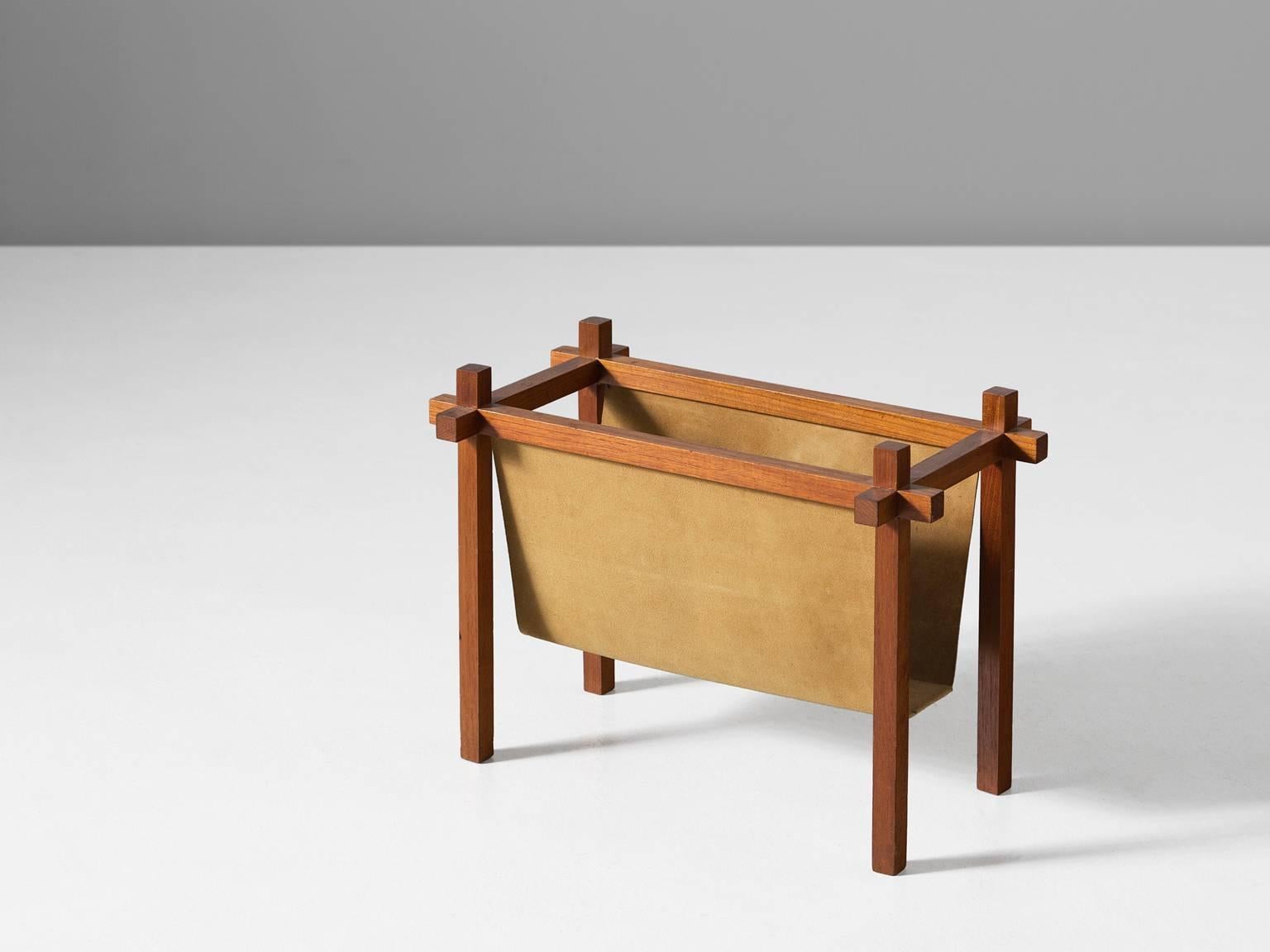 Magazine rack, in teak and leather, by Skjode Skjern, Denmark, 1950s. 

Nice constructed wooden magazine holder with suede. The design is simplistic, yet the construction shows nice wood-joints. A suede cloth hangs in the wooden frame and provides