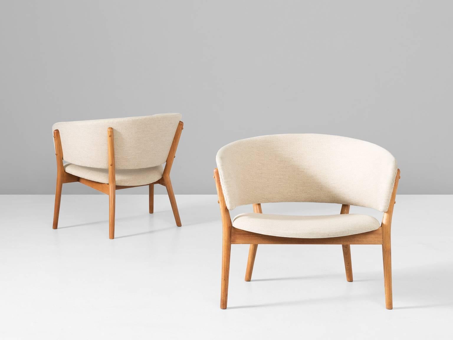 Set of two easy chairs model ND83, in teak and fabric, by Nanna Ditzel for Soren Willadsen, Denmark, 1952.

Set of two round lounge chairs with teak frame and off-white fabric upholstery. The teak frame is beautifully shaped. The back runs over in