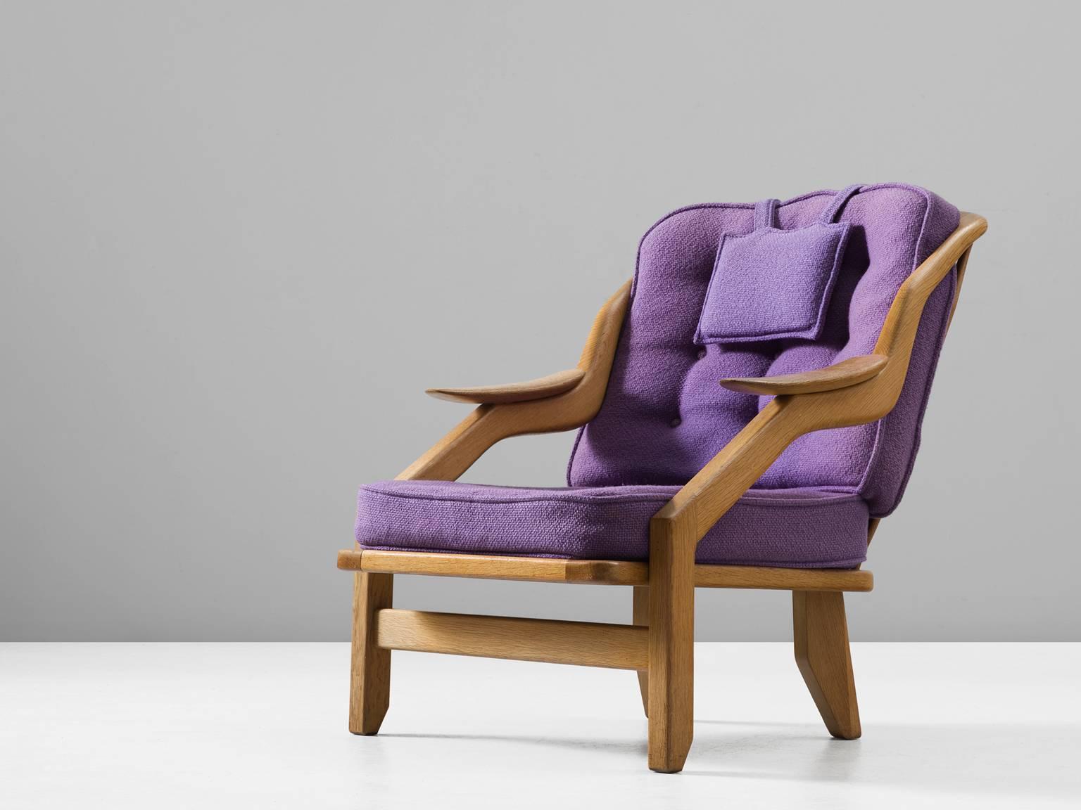 Lounge chair, in oak and fabric, by Guillerme et Chambron, France 1960s. 

Guillerme and Chambron is known for their extreme high quality solid oak furniture, from which this is another great example. This chair has a very interesting shape