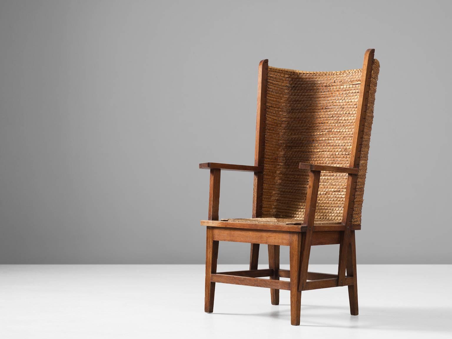 Armchair, in oak and straw, Scotland, 1940s. 

Orkney armchair with woven high back of rush or straw. A traditional oak chair in solid oak with woven seating. Exceptional addition is the high back of woven grass. It gives a secure and sheltered