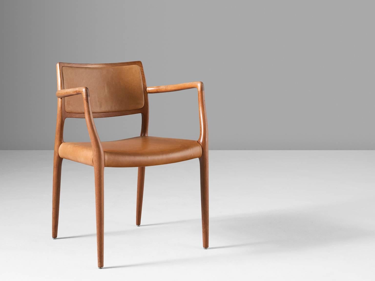 Armchair 'Model 65', in teak and leather, by Niels Otto Møller for J.L. Møllers Møbelfabrik, Denmark, circa 1968. 

Very refined armchair in teak and cognac leather. The natural leather perfectly blends with the solid teak and compliments the