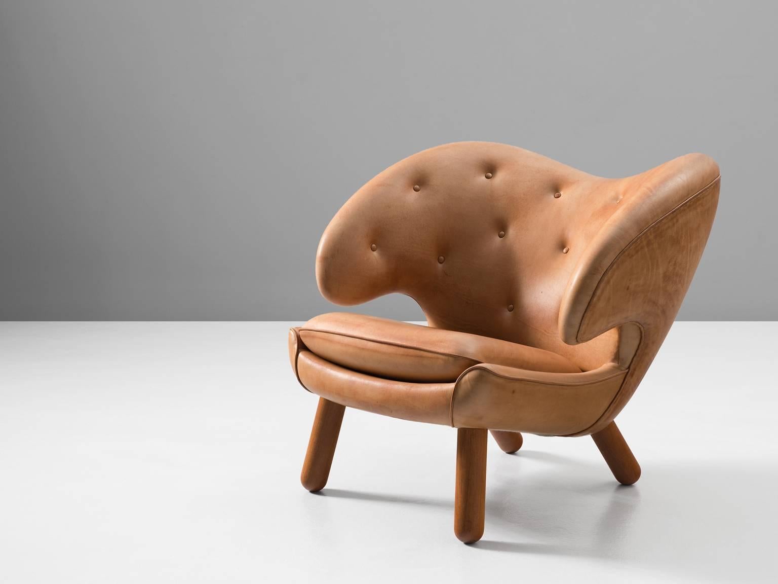 Pelican chair, in wood and leather, by Finn Juhl, Denmark, 1940. 

This chair was designed by Finn Juhl in 1940 and presented on the annual Copenhagen cabinetmakers guild exhibition. As almost all his furniture, the early editions of this chair