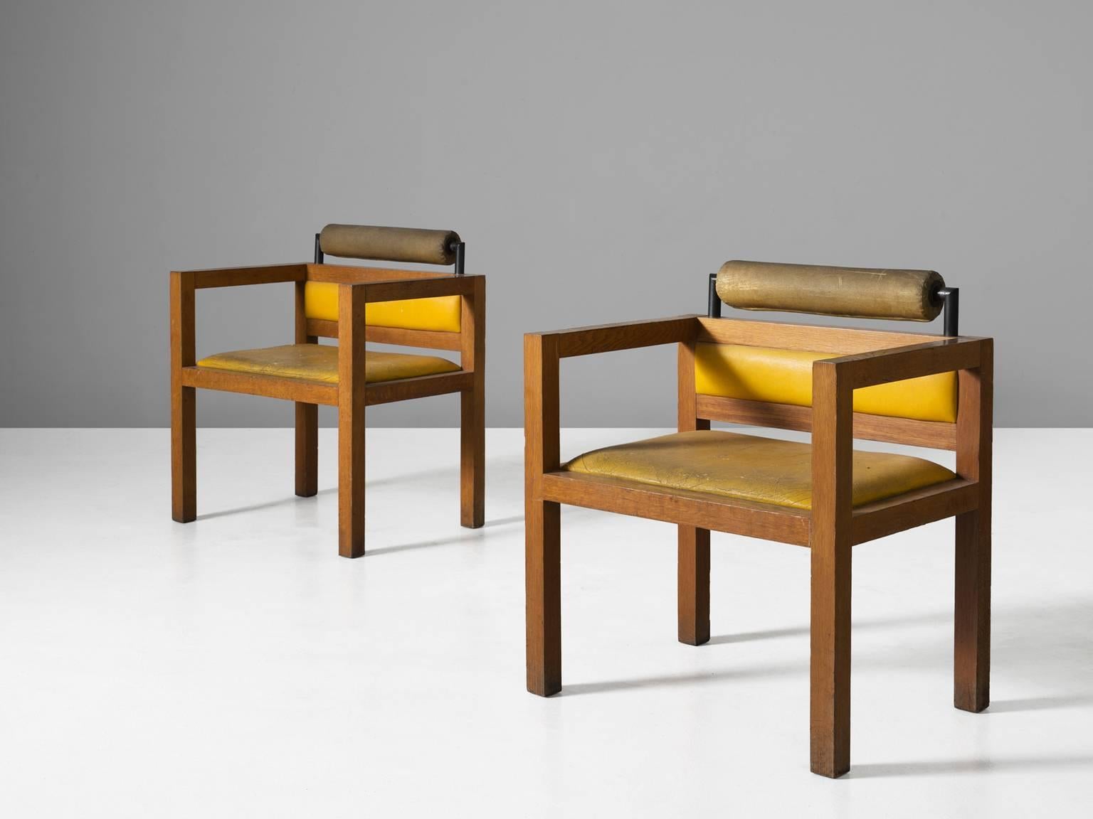 Armchairs, in oak and metal and leather, Italy, 1970s. 

Set of two cubic armchairs in solid oak with yellow and beige leather upholstery. The straight lines and strong angles give these chairs a cubic and sturdy character. The high legs and arms