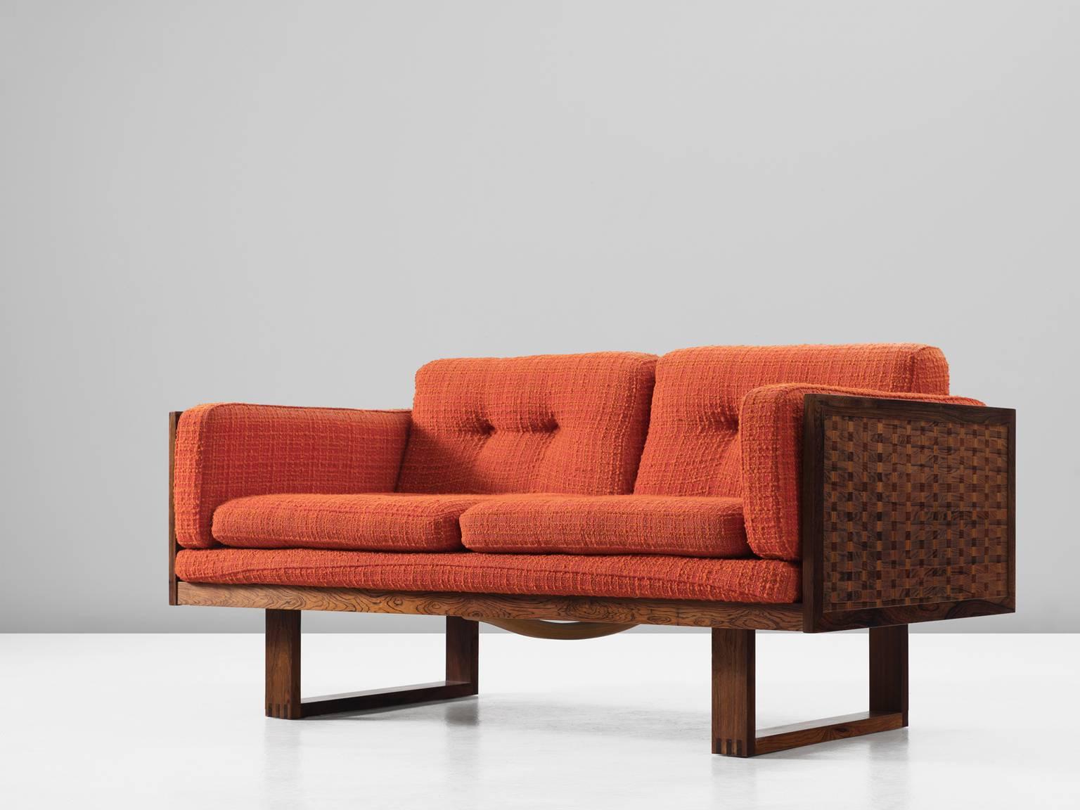 Sofa, in rosewood and fabric, by Poul Cadovious for France & Søn, Denmark, 1960s. 

Settee by Danish designer Poul Cadovious. The frame consists of rosewood. Two sled-legs provide an open look to the more closed sofa. All sides are covered