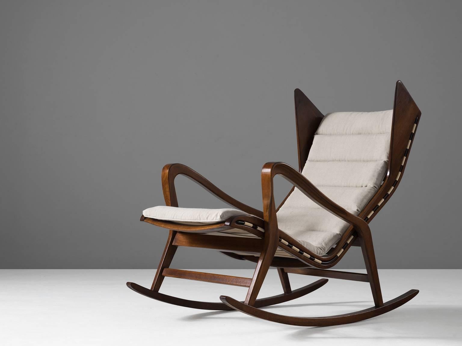 Lounge chair, in walnut and fabric, for Cassina, Italy, 1950s. 

Very rare rocking chair in walnut, designed by the Italian company Cassina, in the style of Gio Ponti. Exquisite production techniques were used which are visible in the beautiful