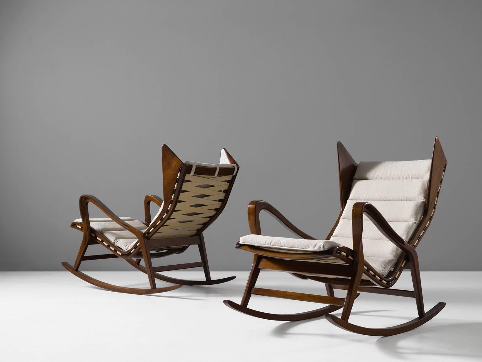 A pair of lounge chairs, in walnut and fabric for Cassina, Italy, 1950s. 

Very rare set of rocking chairs in walnut, designed by the Italian company Cassina, in the style of Gio Ponti. Exquisite production techniques were used which are exposed