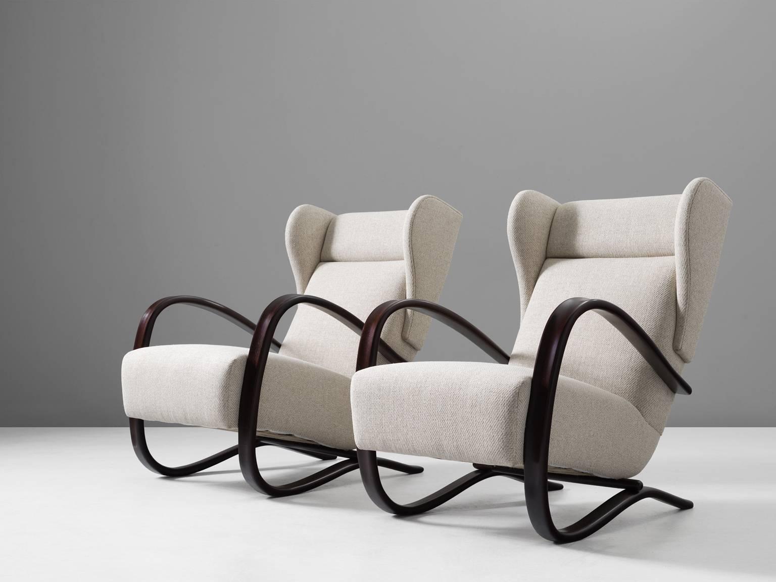 Jindrich Halabala, pair of armchairs, in stained beech and fabric, by  Czech Republic, 1930s. 

This Halabala chairs are part of the Morentz midcentury design collection. These lounge chairs have a very dynamic appearance, due the curved base that