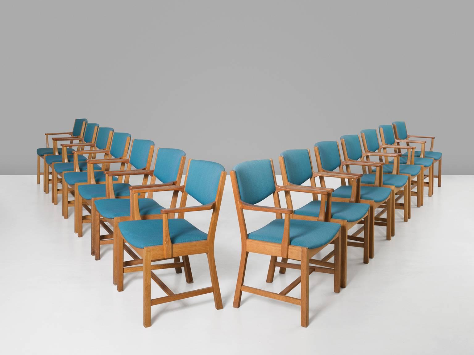 Set of 14 dining chairs, in oak and fabric, for Sorø Stolefabrik, Denmark, 1950s.

Large set of dining room chairs in oak and blue fabric upholstery. The wooden frame shows beautiful lines. Quite cubic and straight on the front and nicely curved