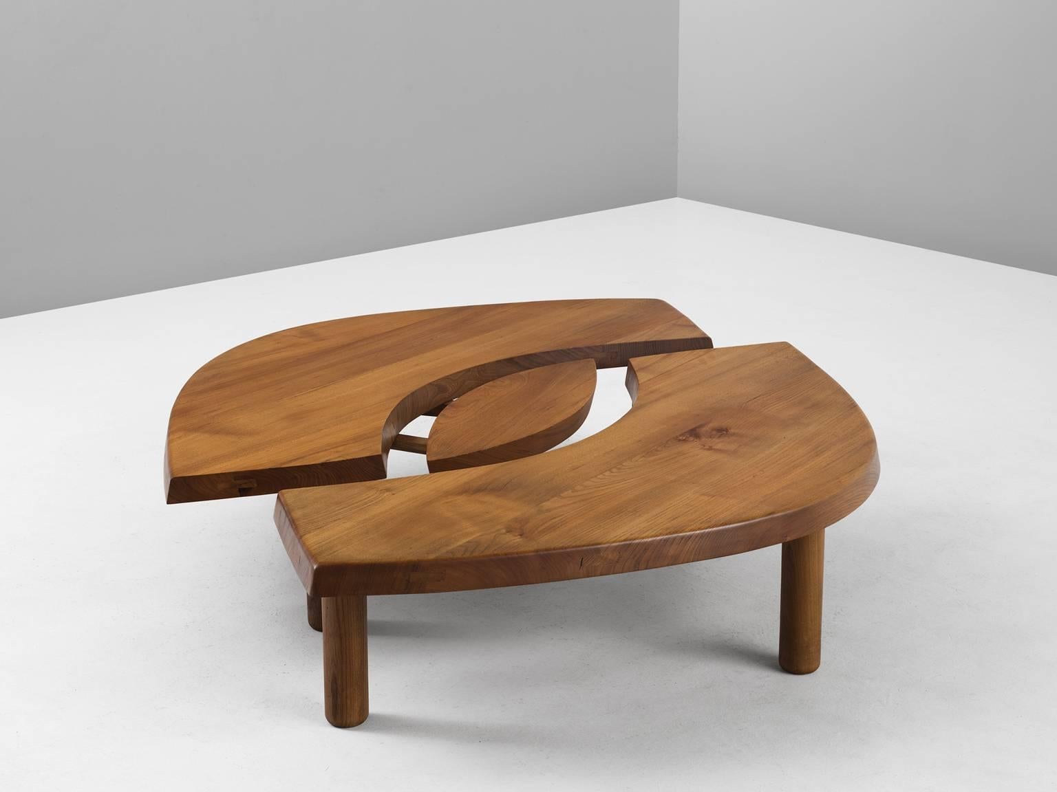 Coffee table T22, in elm, by Pierre Chapo, France, 1960s.

Beautiful eye-shaped cocktail table by French designer and master woodworker Pierre Chapo. This table consists of two arch-shaped tables and one oval middle. Interesting wood joints are